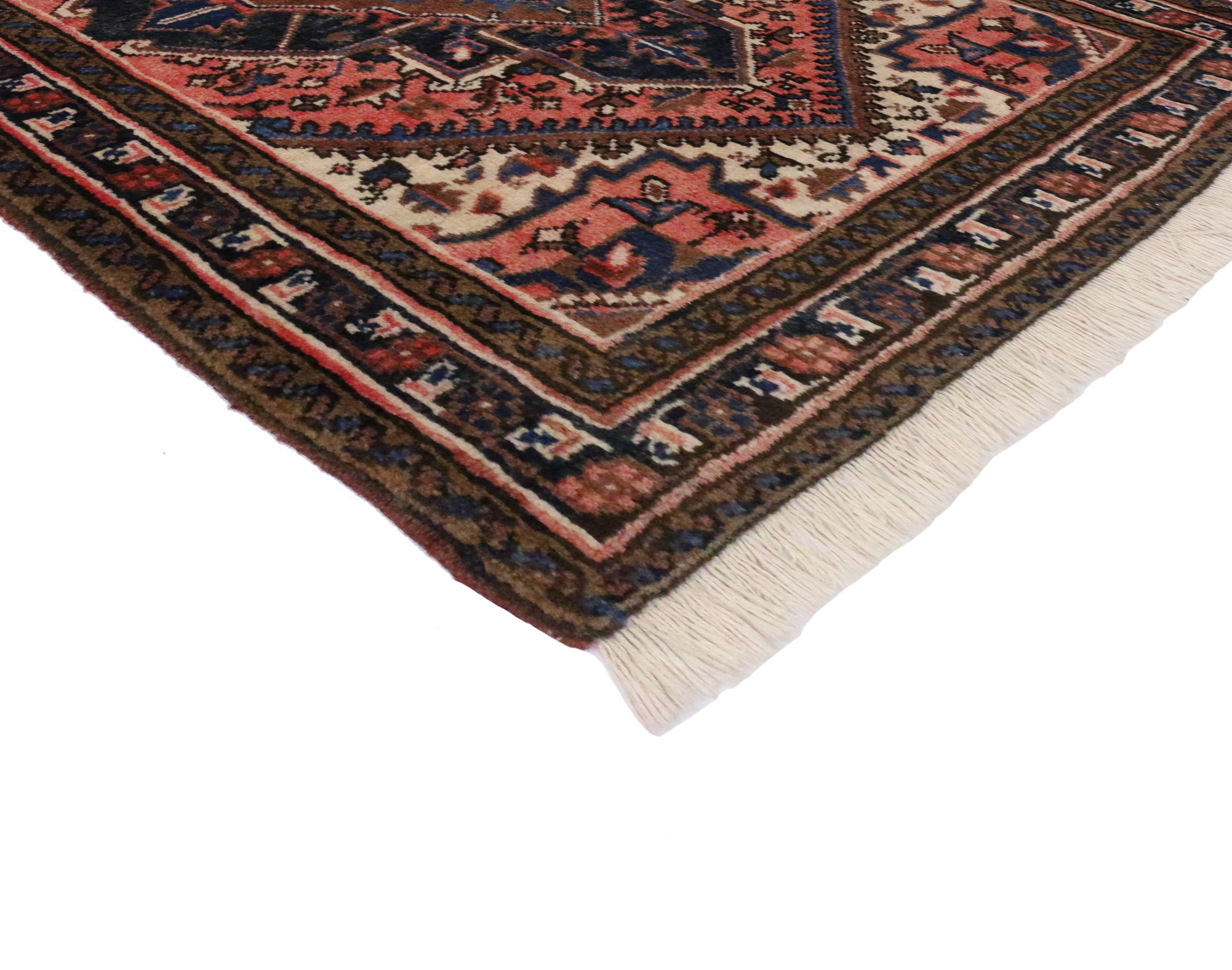 Fashionably incorporating a modern vibe while creating a sense of excitement with the dramatic color shifts radiating throughout, this vintage Persian rug is deeply captivating. Features an ornate center medallion with an all-over geometric pattern