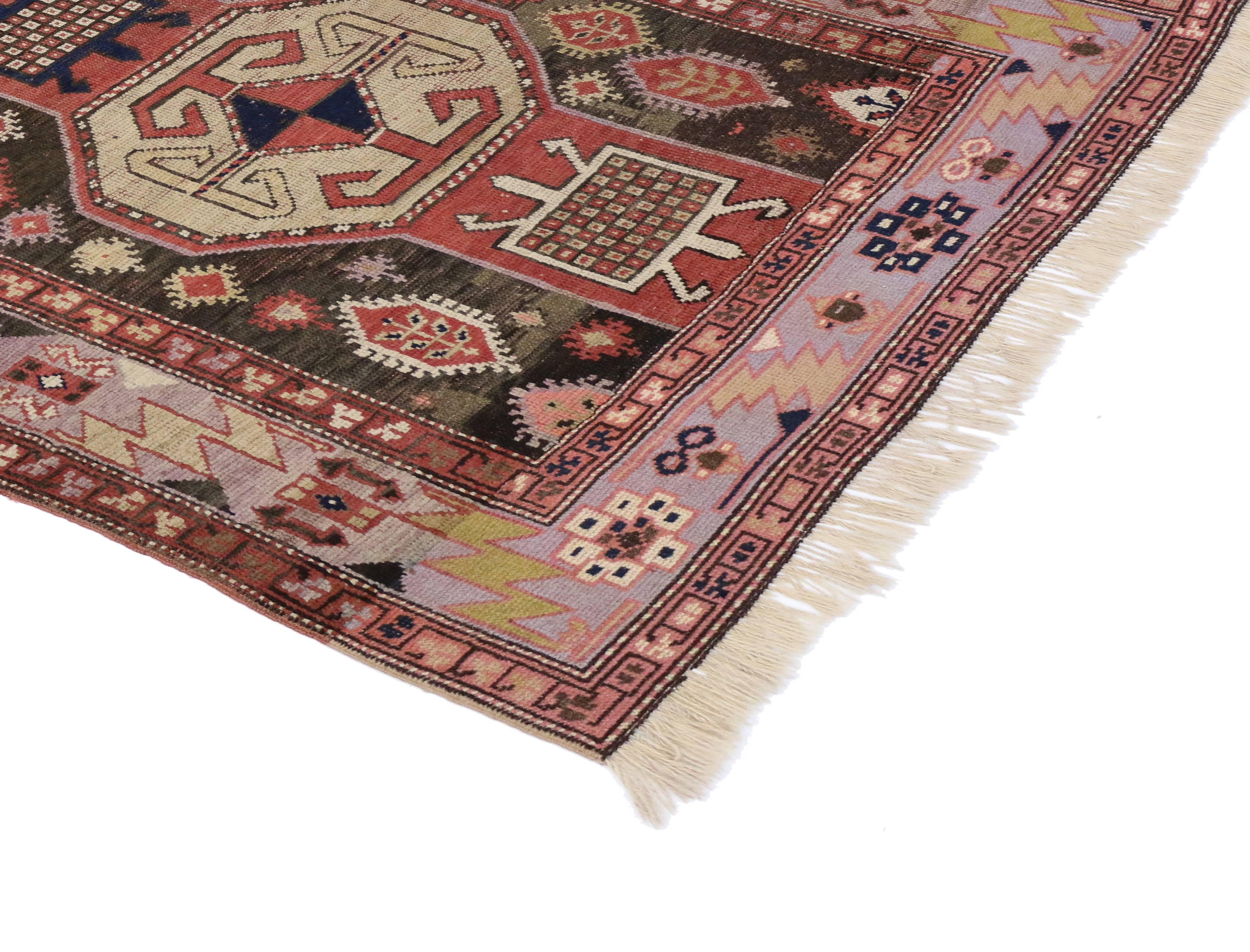 Vintage Persian Azerbaijan rug with boho chic style featuring a tribal design and geometric motifs in an abrashed field of soft, neutral colors. Highlighting a Primitive design with the symbolic ram’s Horn motif, this vintage rug creates a