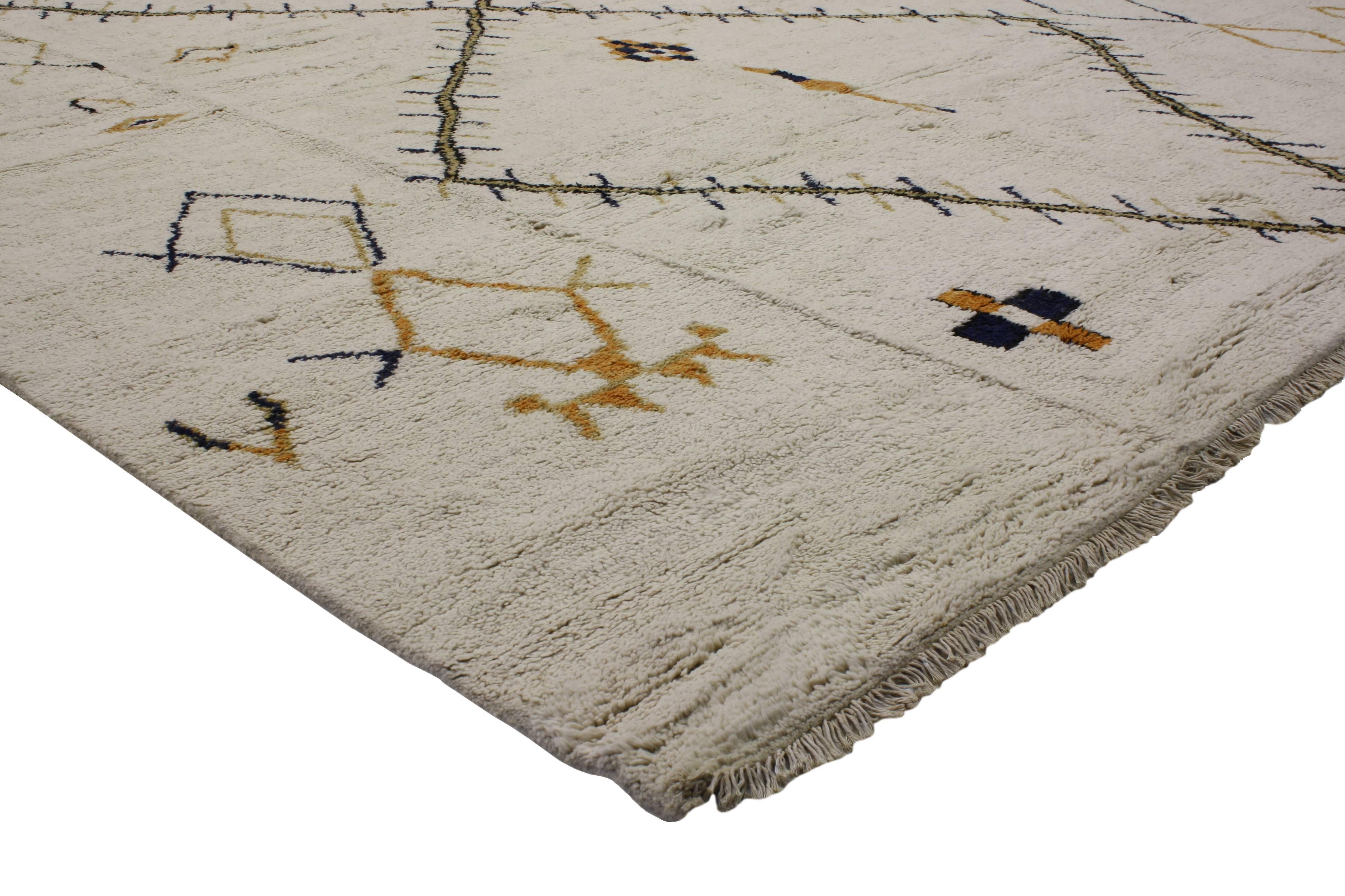 This Moroccan area rug harmonizes disparate elements, brings soothing serenity while adding texture and depth to your space. Featuring plush piled wool and ancient talisman symbolism, this Primitive rug has the ability to connect the feel of nomadic