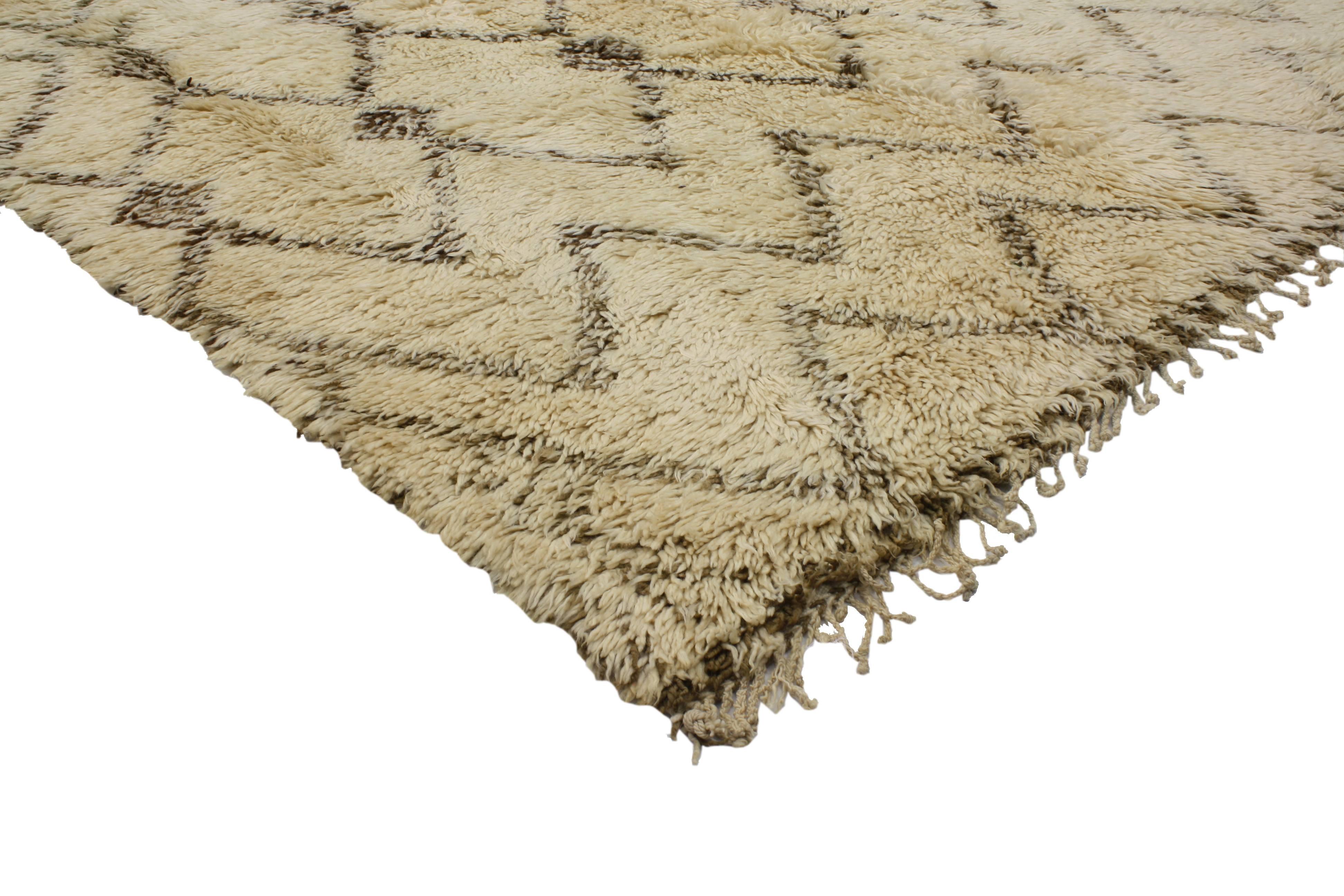 Side with pattern and texture in a modern space for a look that commits to casual elegance and comfort in this vintage Beni Ourain Moroccan rug. With its plush piled wool and ancient Moroccan talisman symbolism, this Beni Ouarain rug connects