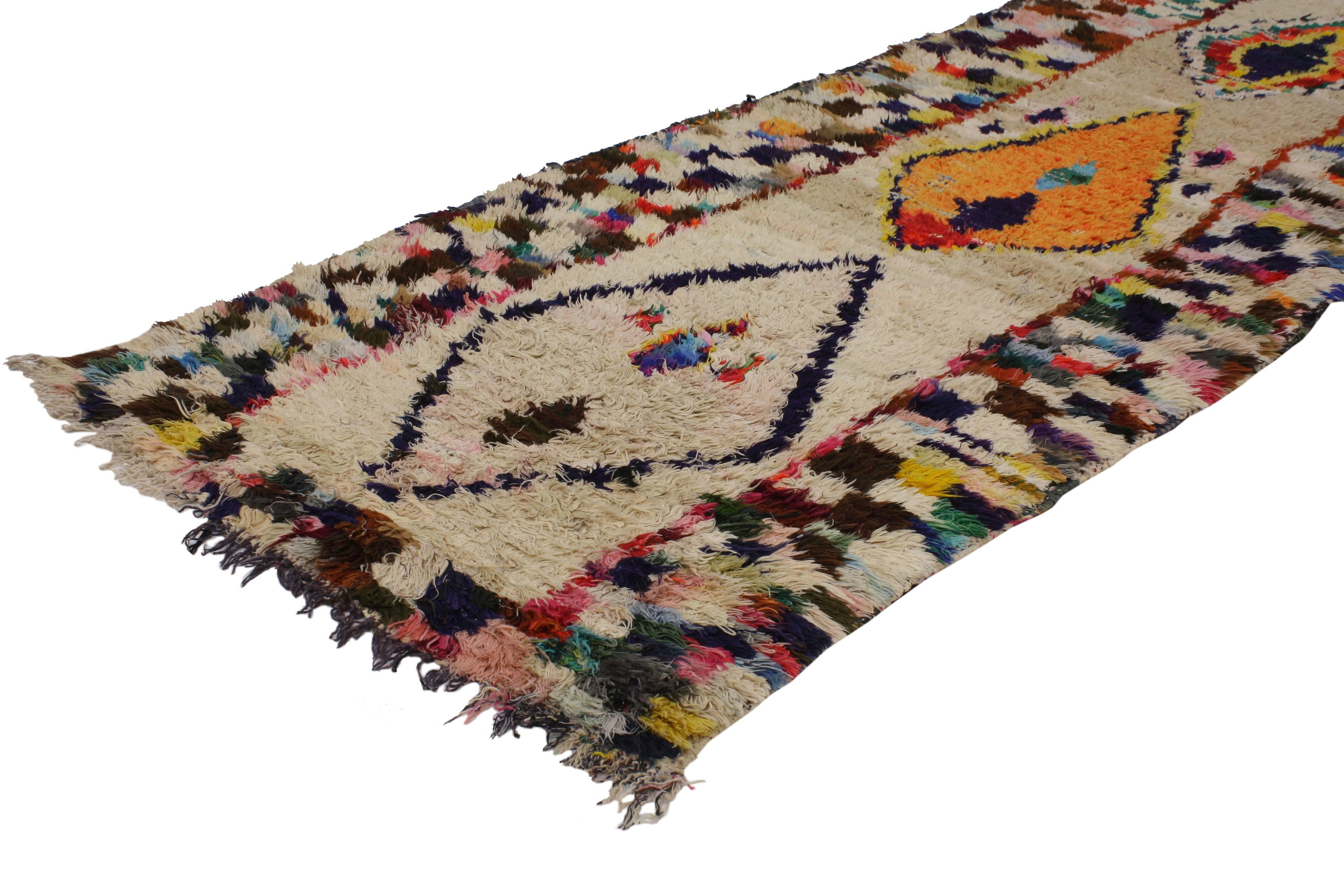 With its Primitive charm and boho chic style, this vintage Berber Moroccan runner with modern tribal design conveys a sense of beauty and mystery. Impeccably woven from hand-knotted wool in vibrant colors, this Moroccan rug runner does an excellent