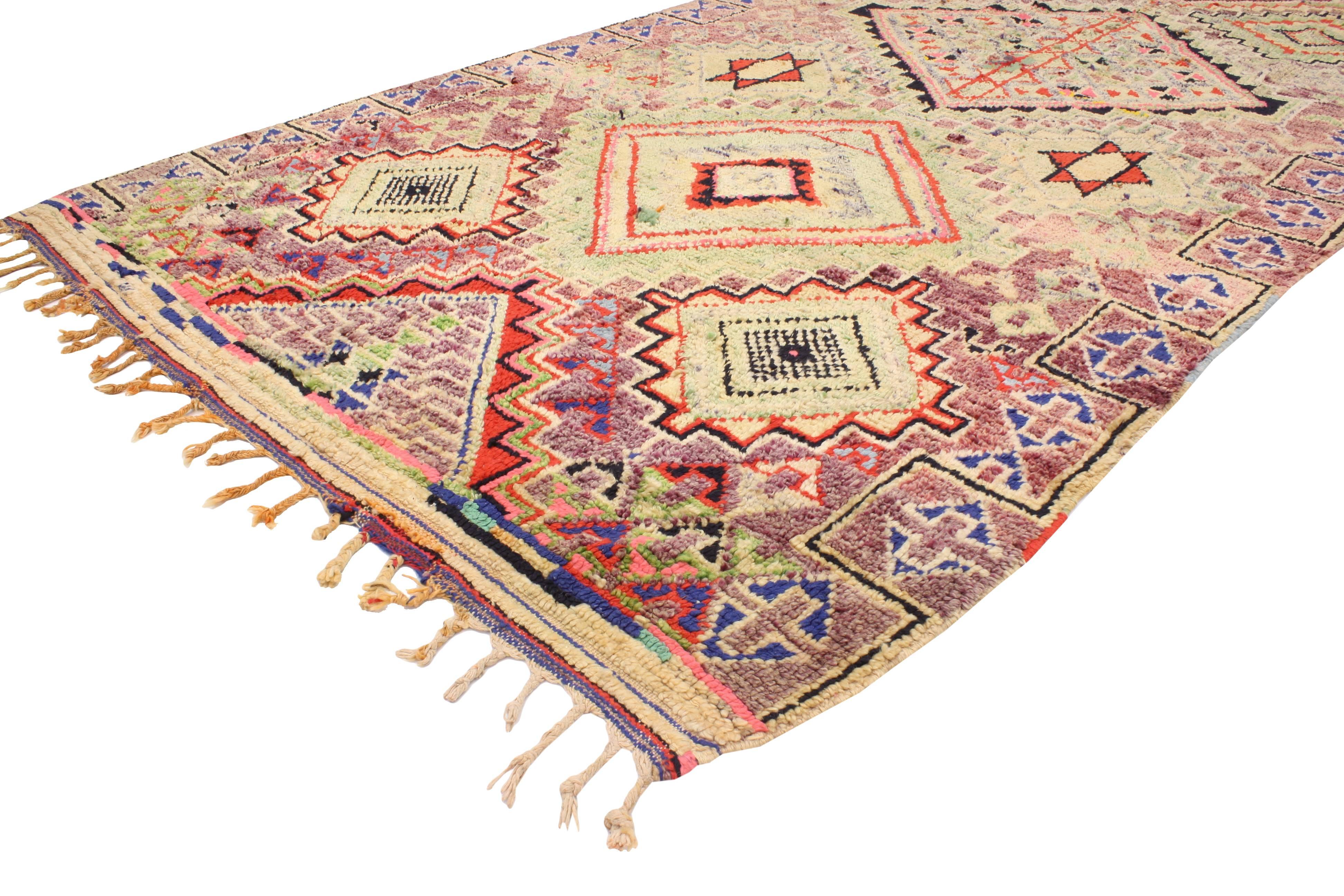 Immersed in ancient Berber Tribe symbols and the Star of David, this vintage Berber Moroccan rug features a modern tribal style with Judaic influence. Rendered in pastel hues of lavender, pink, blush, orange, plum, soft mint green with accents of