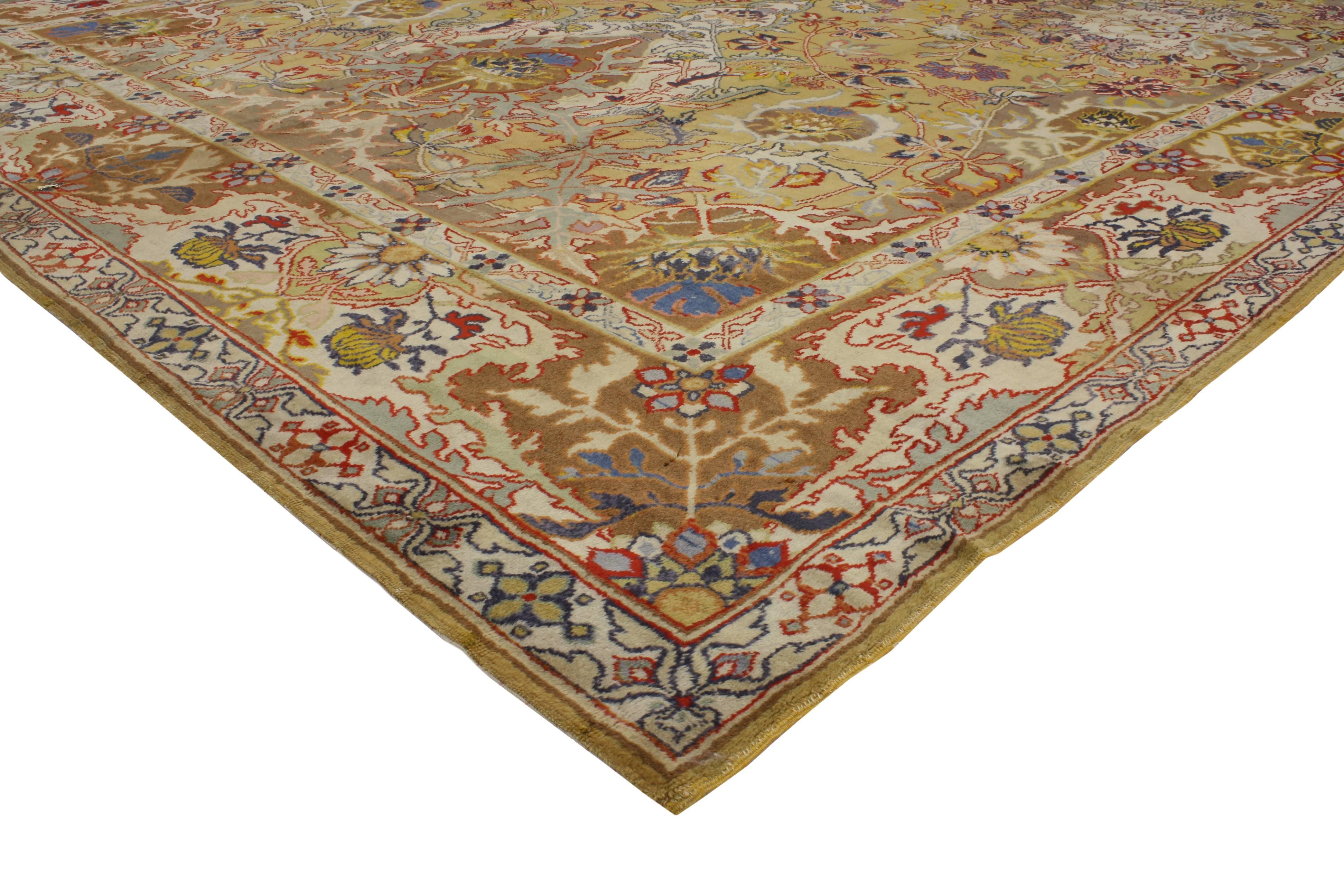 This antique European rug features an Oushak Design and traditional modern style. It is characterized by grand scale elements of design and a beautiful golden yellow field. Large geometric motifs create a majestic cadence throughout this