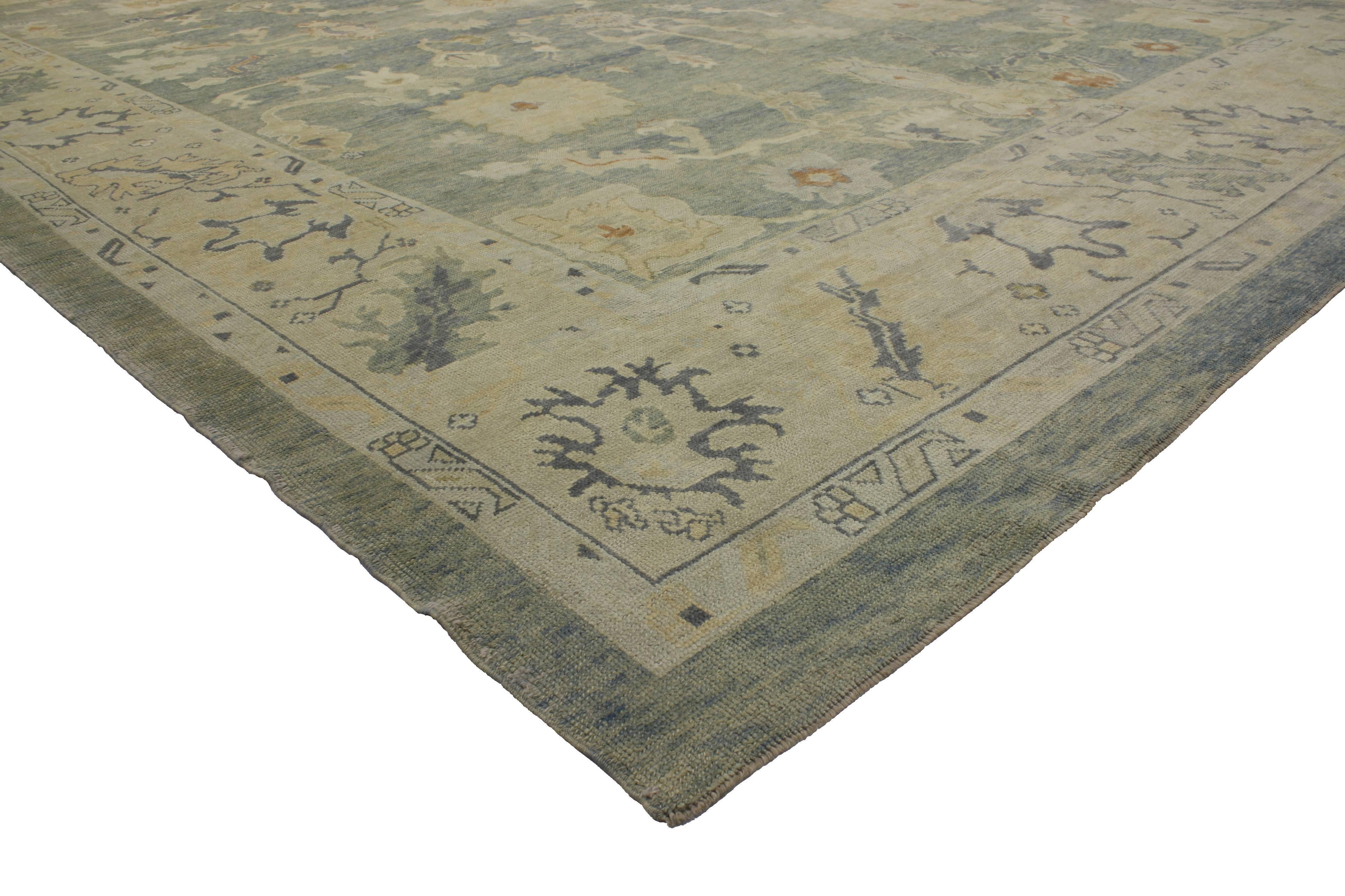 Showcasing a Classic Oushak design and subtle, airy color palette, this modern rug keeps the eyes entertained, but it is still serene and relaxing. This modern Oushak rug has such an elegant feel, the dreamy ocean colored field feels fresh and soft