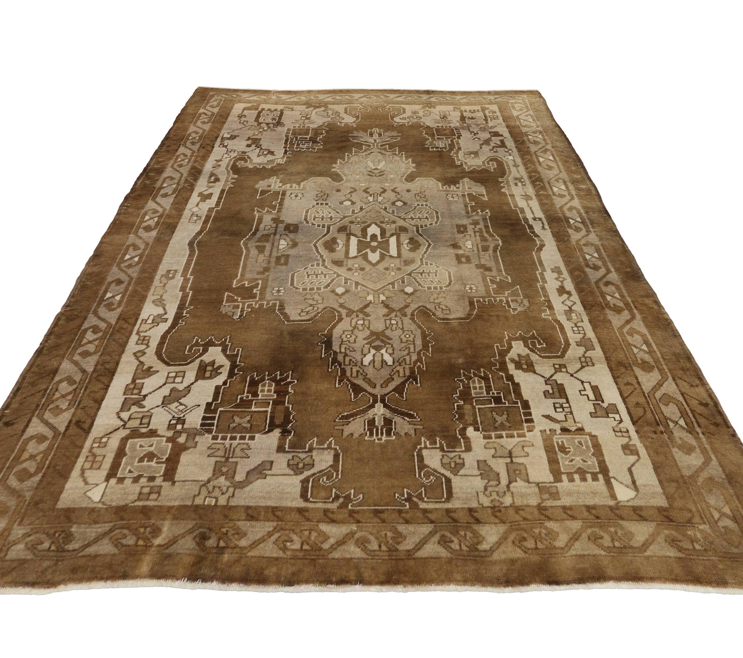 Full of character and stately presence, this vintage Kars rug with Mid-Century Modern style showcases an extravagant geometric design rendered in beautiful variegated shades of brown, tan, beige, gray, Chamoisee, ecru, greige and cream. Featuring an