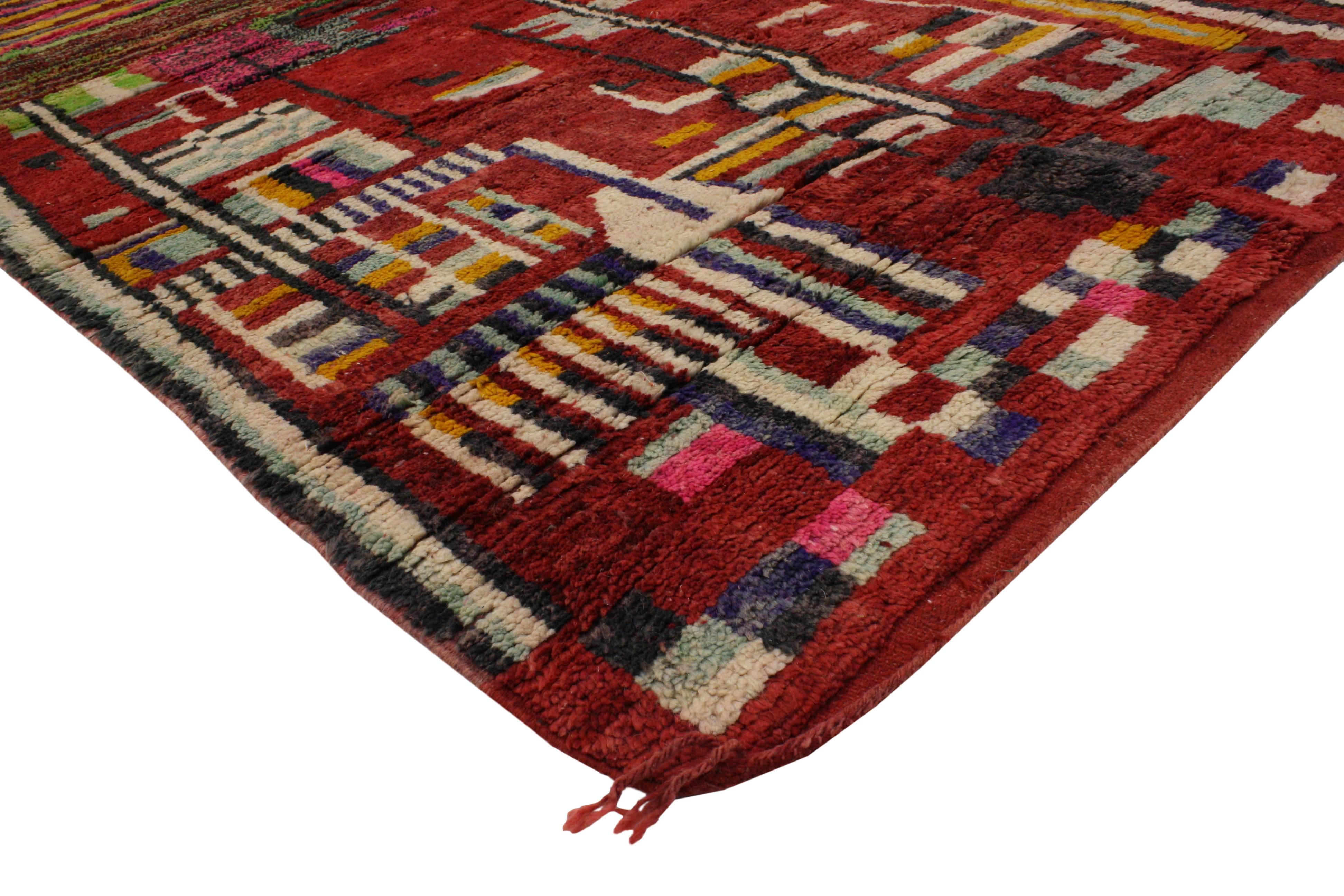 Impeccably woven from hand-knotted wool and free-form designs, this Berber Moroccan rug features a clean design with Mid-Century Modern and Brutalist influence. Showcasing a modern style and saturated red background, this Berber Moroccan rug adds