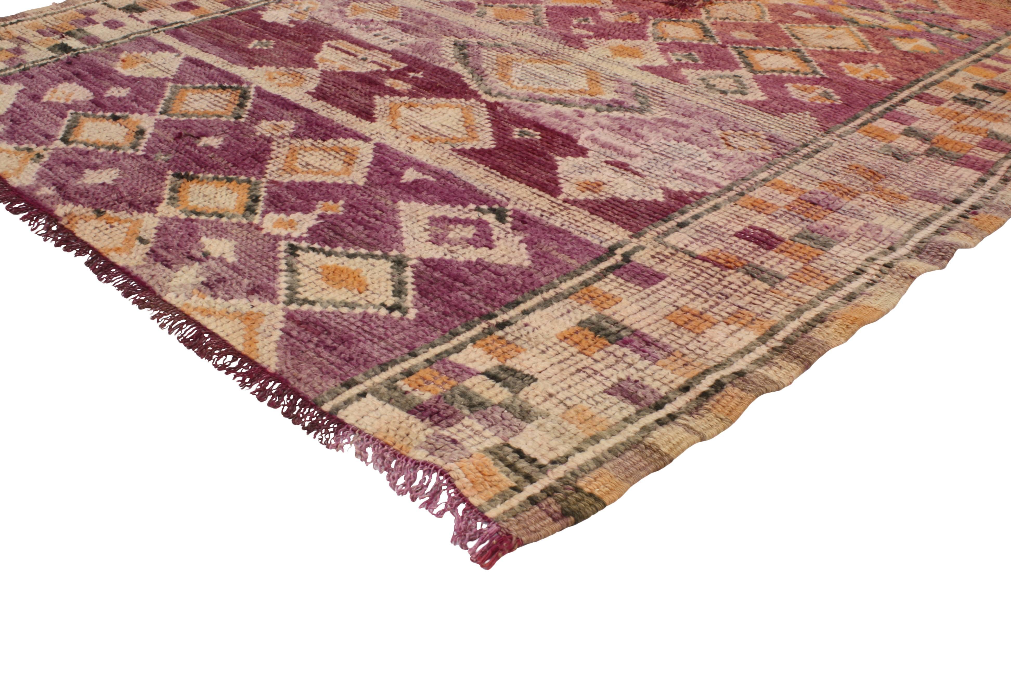 Bursting of Indian summer colors from raspberry, mulberry, plum and lavender to salmon, pink, blush, apricot and orange, this vintage Berber Moroccan rug is a fantastic way to invite flair and create a bright and enigmatic atmosphere in your home.
