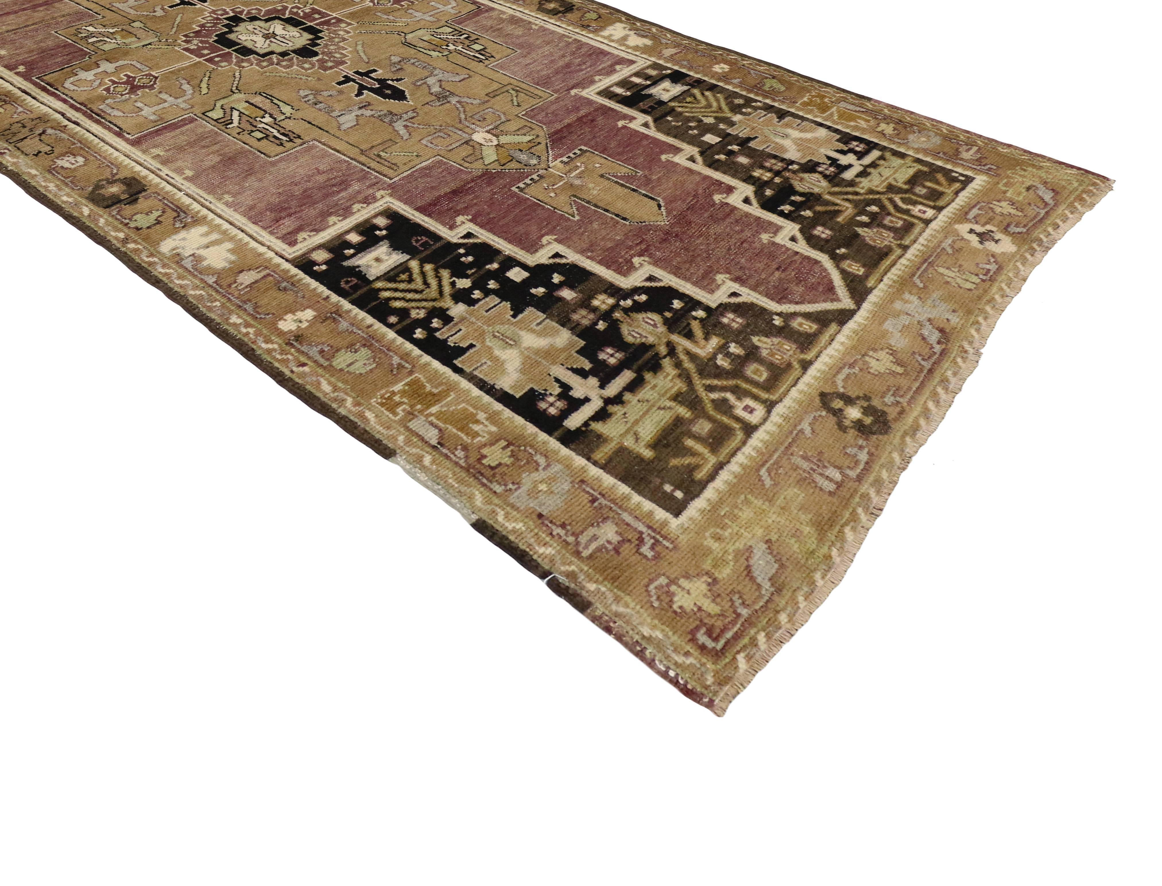 50291 Antique Turkish Oushak Runner with Modern Tribal Style. This hand-knotted wool antique Turkish Oushak runner features a centre medallion in an open field enclosed by stair-step spandrels and a rectilinear palmette and vine border. Rendered in