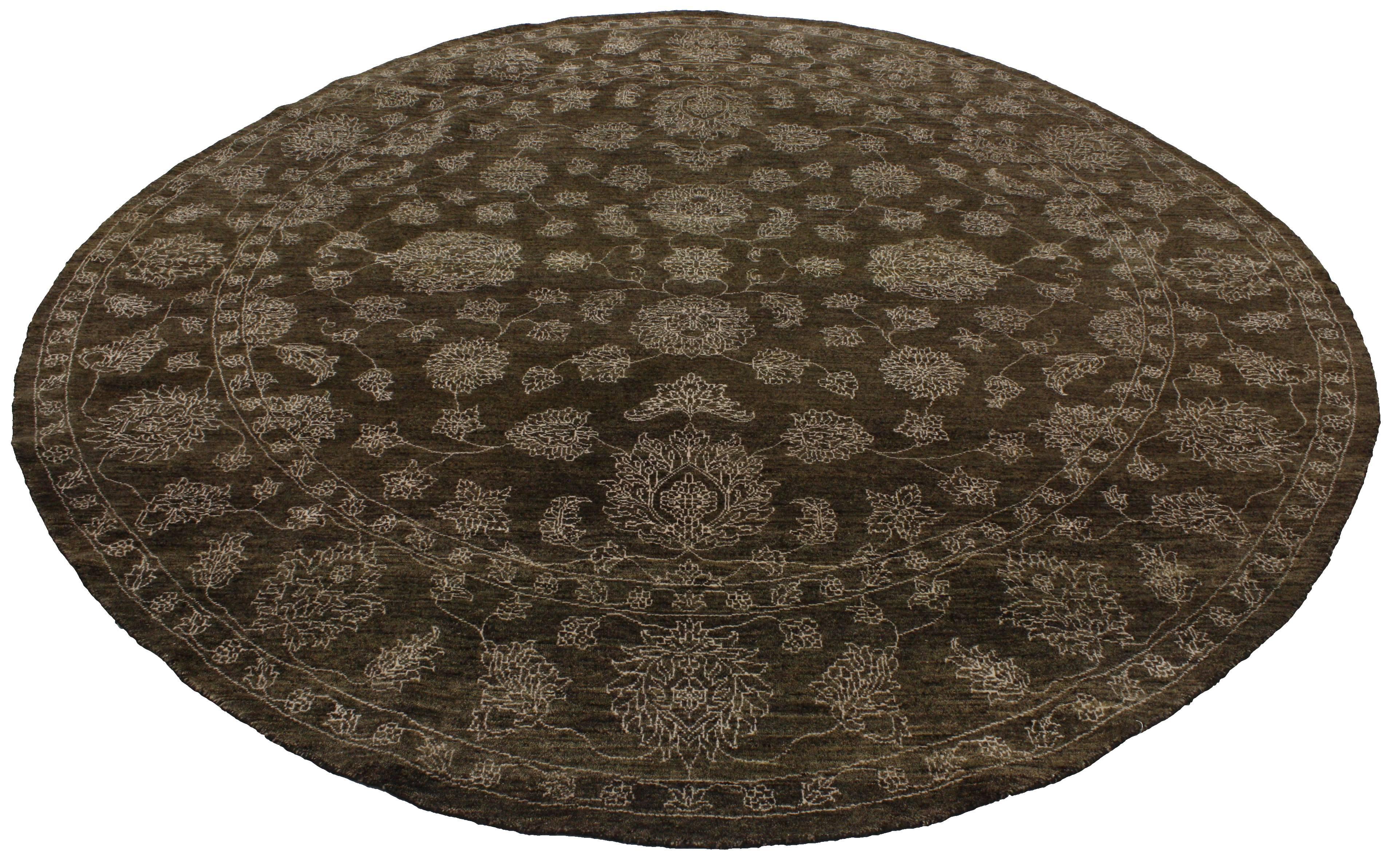 Timeless and refined, this round brown Oushak rug features modern traditional style. Sporting a simple yet refined and polished all-over geometric floral design, this round Oushak rug effortlessly blends well with modern or contemporary-styled