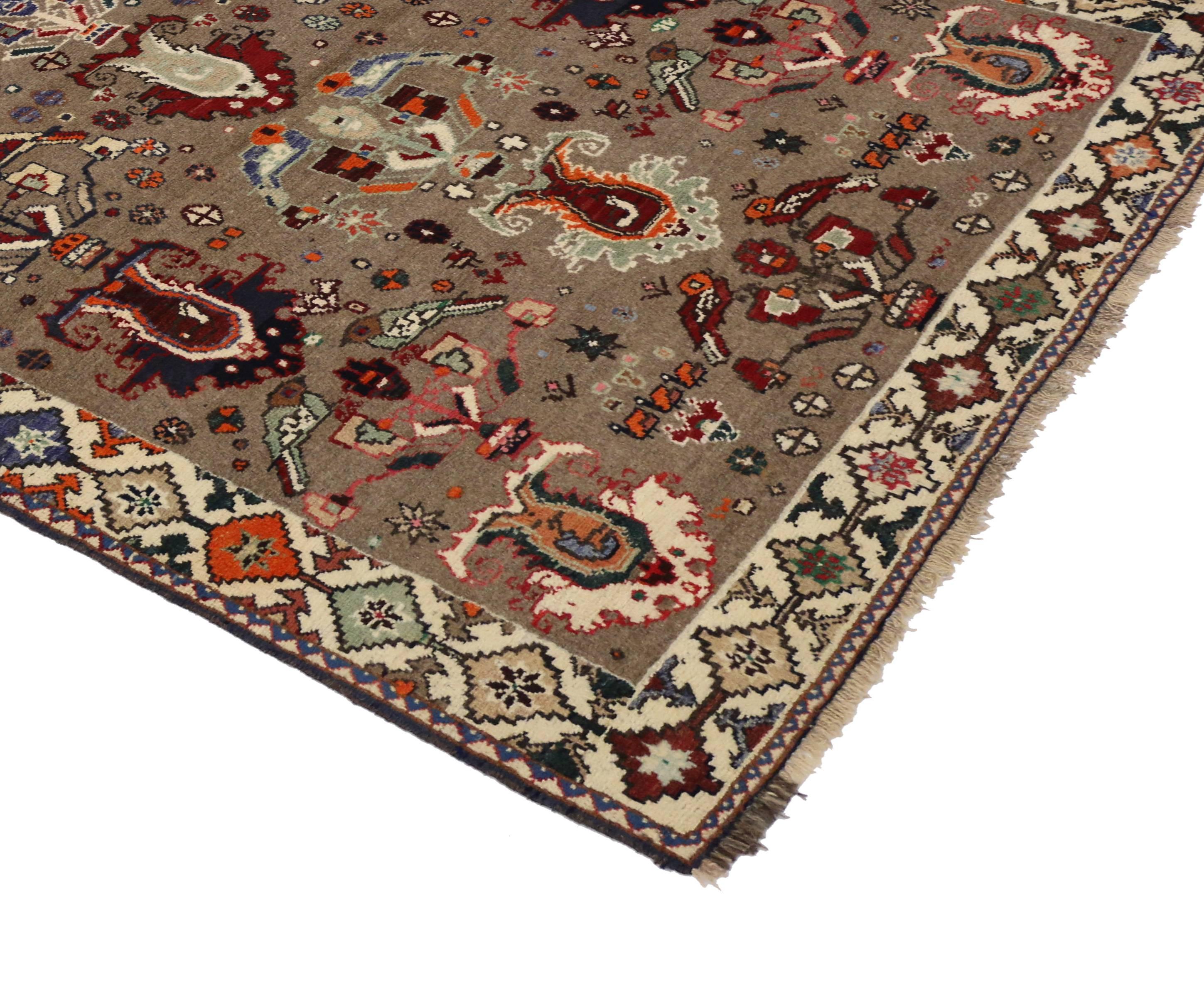 Hand-knotted wool vintage Persian Shiraz rug with modern tribal style. Featuring large-scale motifs of birds and Persian vases on a neutral taupe background surrounded by a complementary geometric border. The color palette consists of taupe, gray,