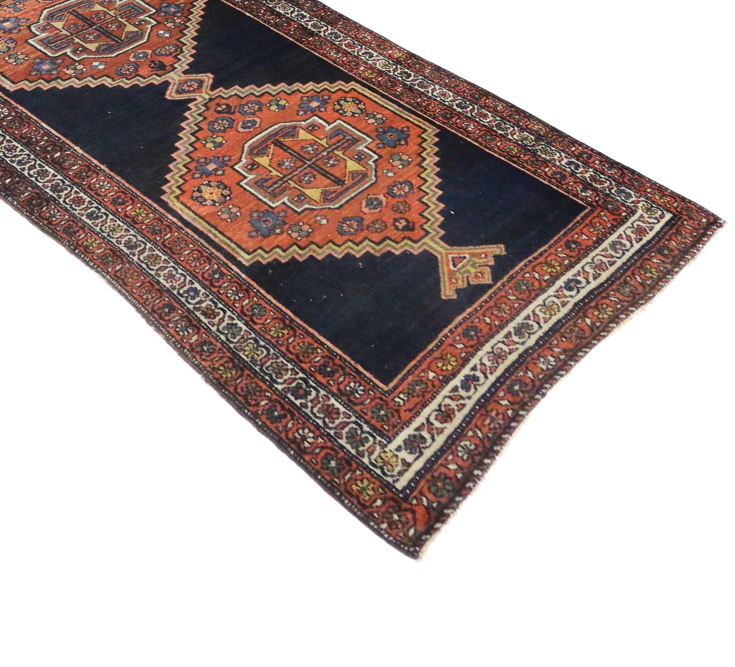 Full of character and stately presence, this antique Persian Hamadan runner with modern tribal style showcases an extravagant geometric design rendered in navy, black, orange, rust, blue, pink, brown, tan and ivory-beige. Highlighting an intrinsic