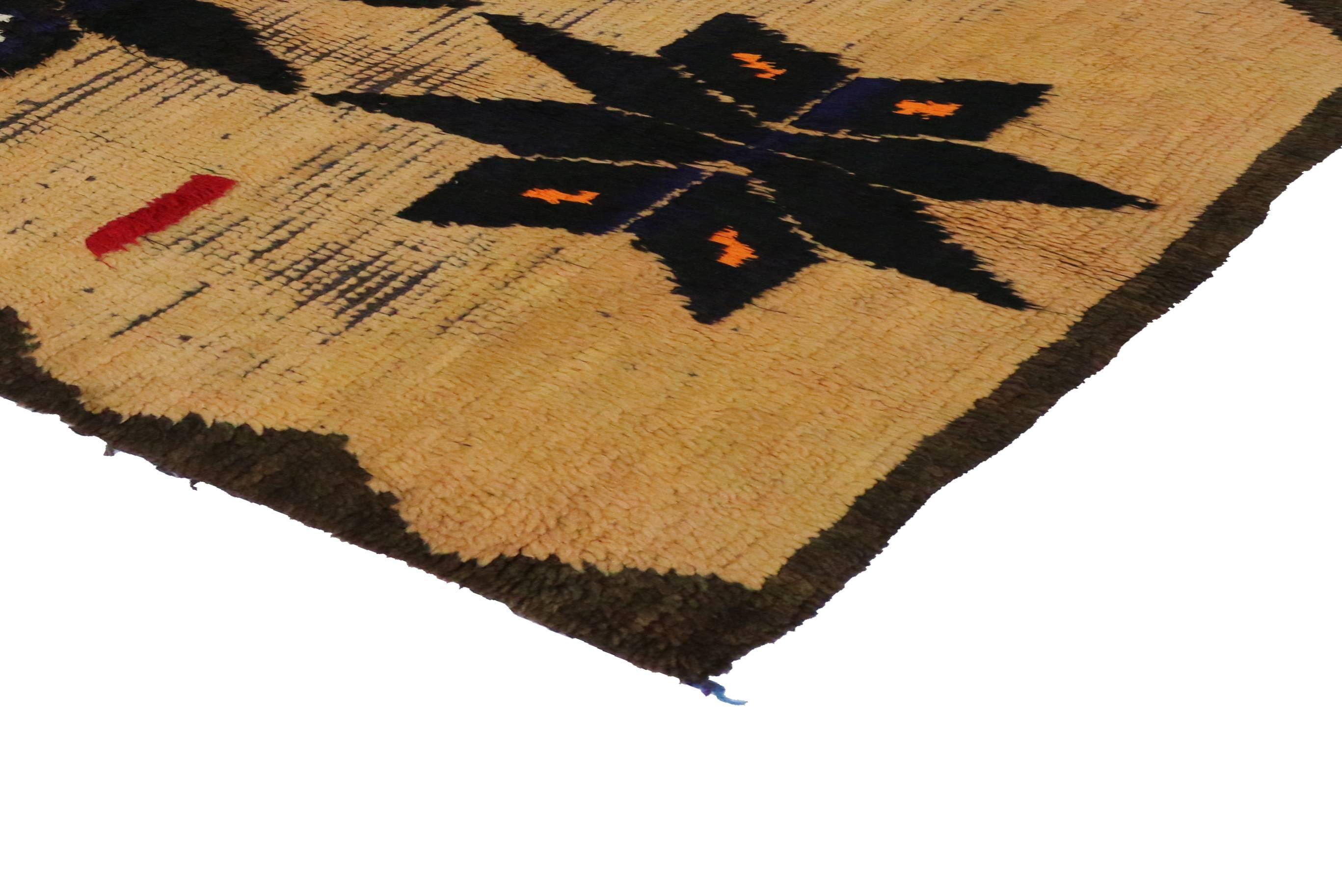 20048 Vintage Berber Moroccan Rug with Modern Tribal Style. This vintage Berber Moroccan rug with modern tribal style features four eight-point black motifs in an abrashed golden field and colorful purple and aqua fringe. With its tribal style and