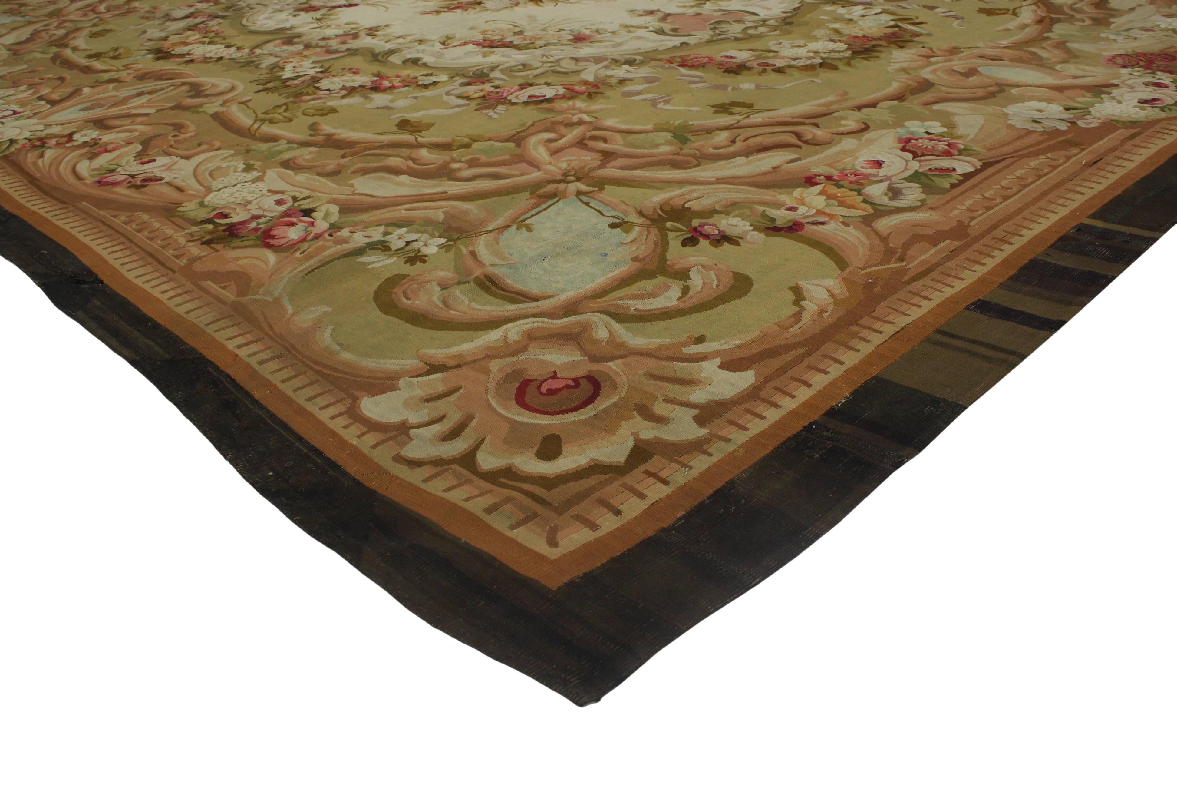 76903 Antique French Aubusson Palace Size Rug with Rococo Louis XV Savonnerie Style. This French Aubusson rug features romantic florals against an ivory-beige and pale green field. Characterized by predominate French influence with its ornate