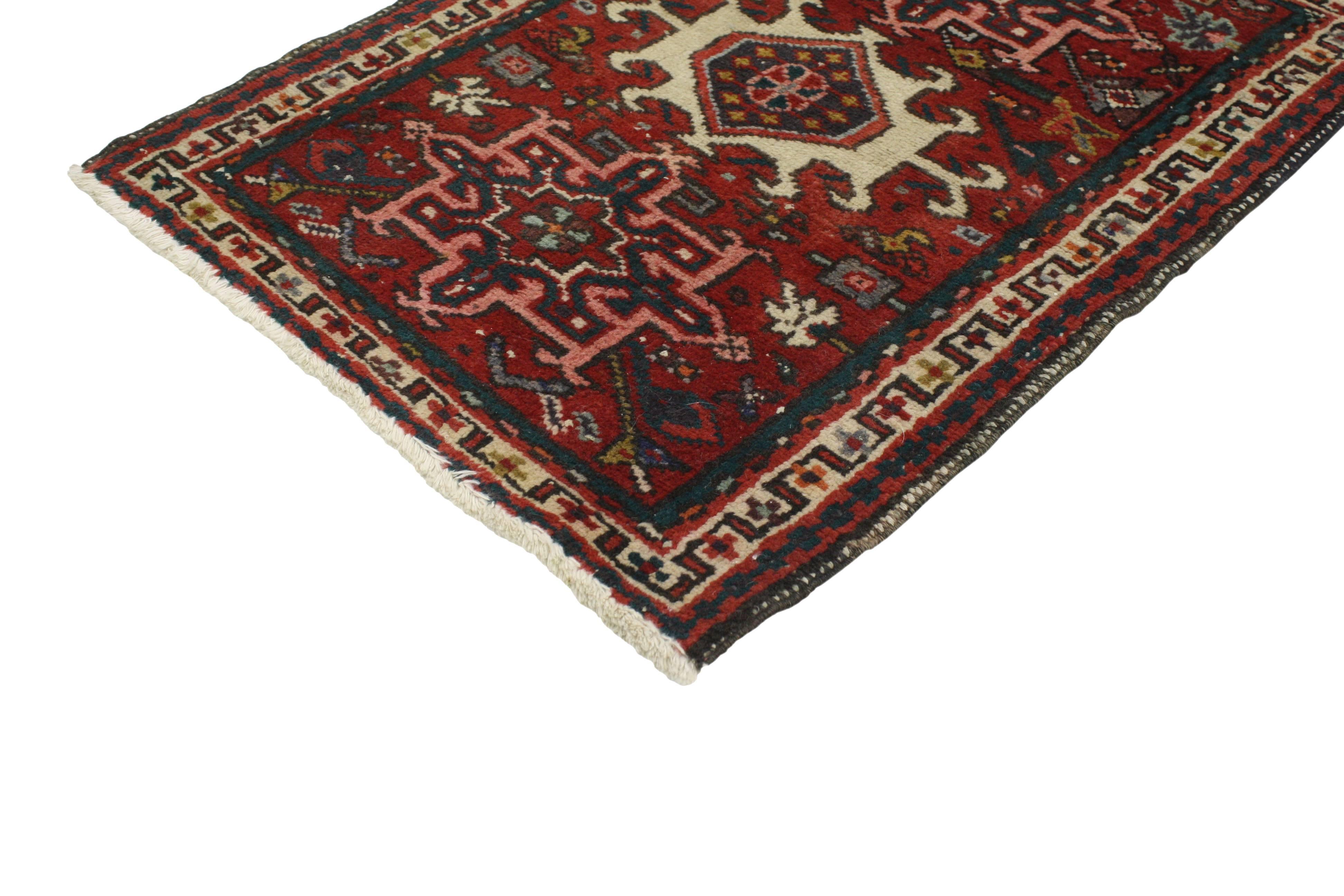 This vintage Heriz Persian rug features a modern traditional style. The red field highlights three large-scale medallions and all-over geometric motifs surrounded by a beige border. Rendered in a traditional color palette of red, blue, beige, pink,