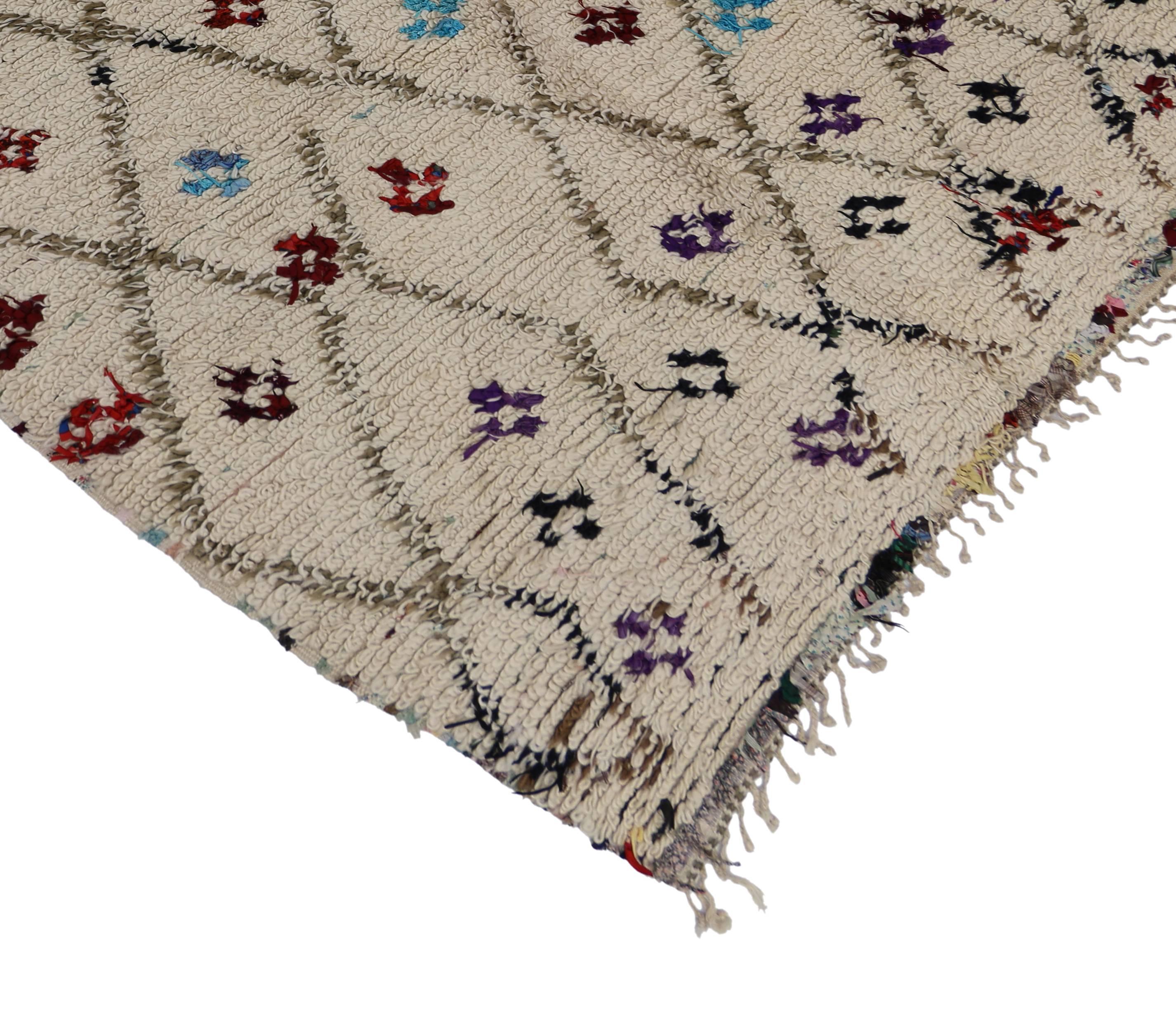 This vintage Berber Moroccan Azilal rug was made from the weaver's imagination while the colors and diverse Berber Tribe motifs were chosen as expressions of ancient Moroccan tradition. This Moroccan Azilal rug showcases true simplistic style with a
