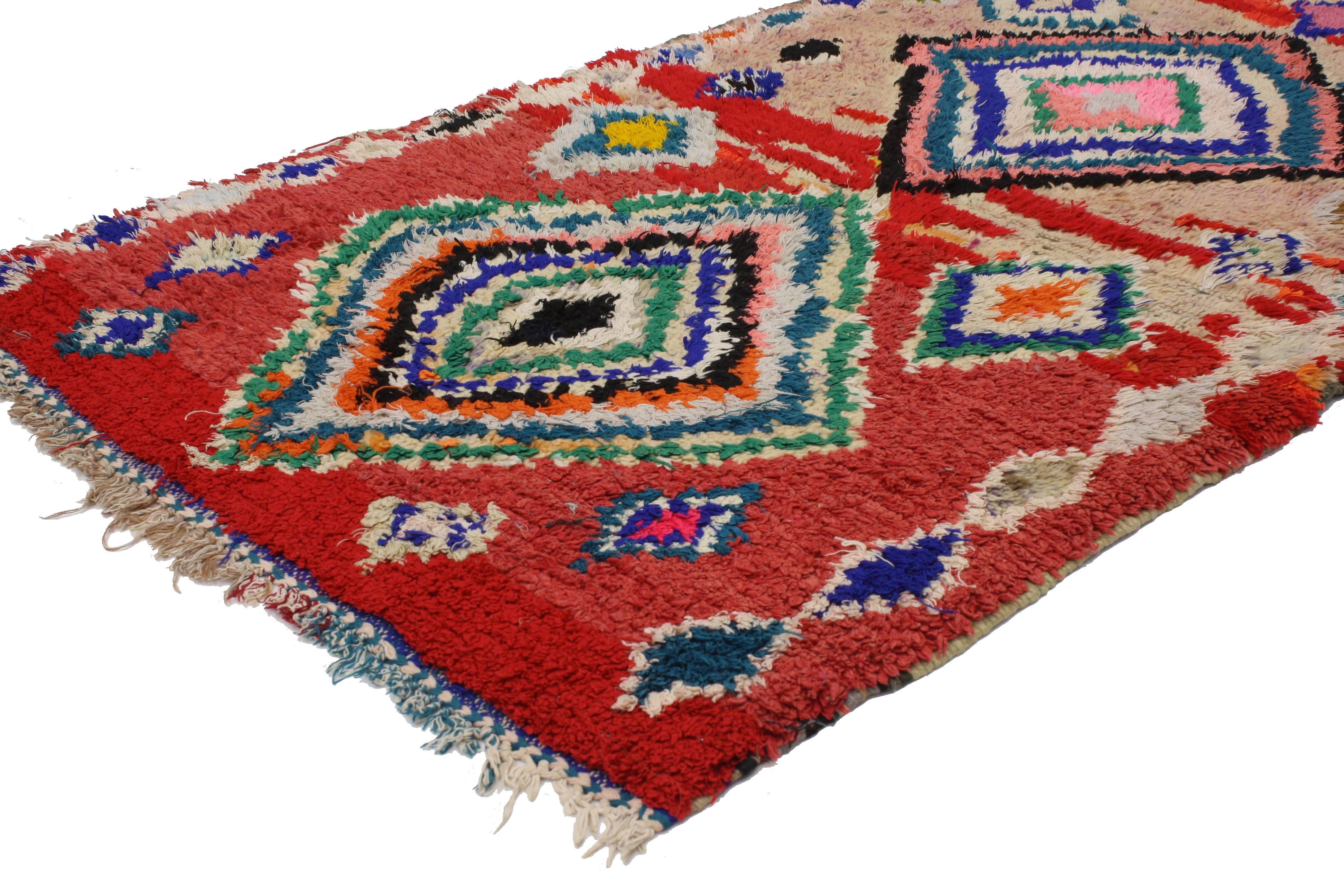 With the dramatic red color and modern tribal style, this vintage Berber Moroccan rug is not for the timid. Rendered in red, hot pink, blue, teal, aqua, green, powder blue, black, gray, lavender with colorful accents. Features two large diamonds