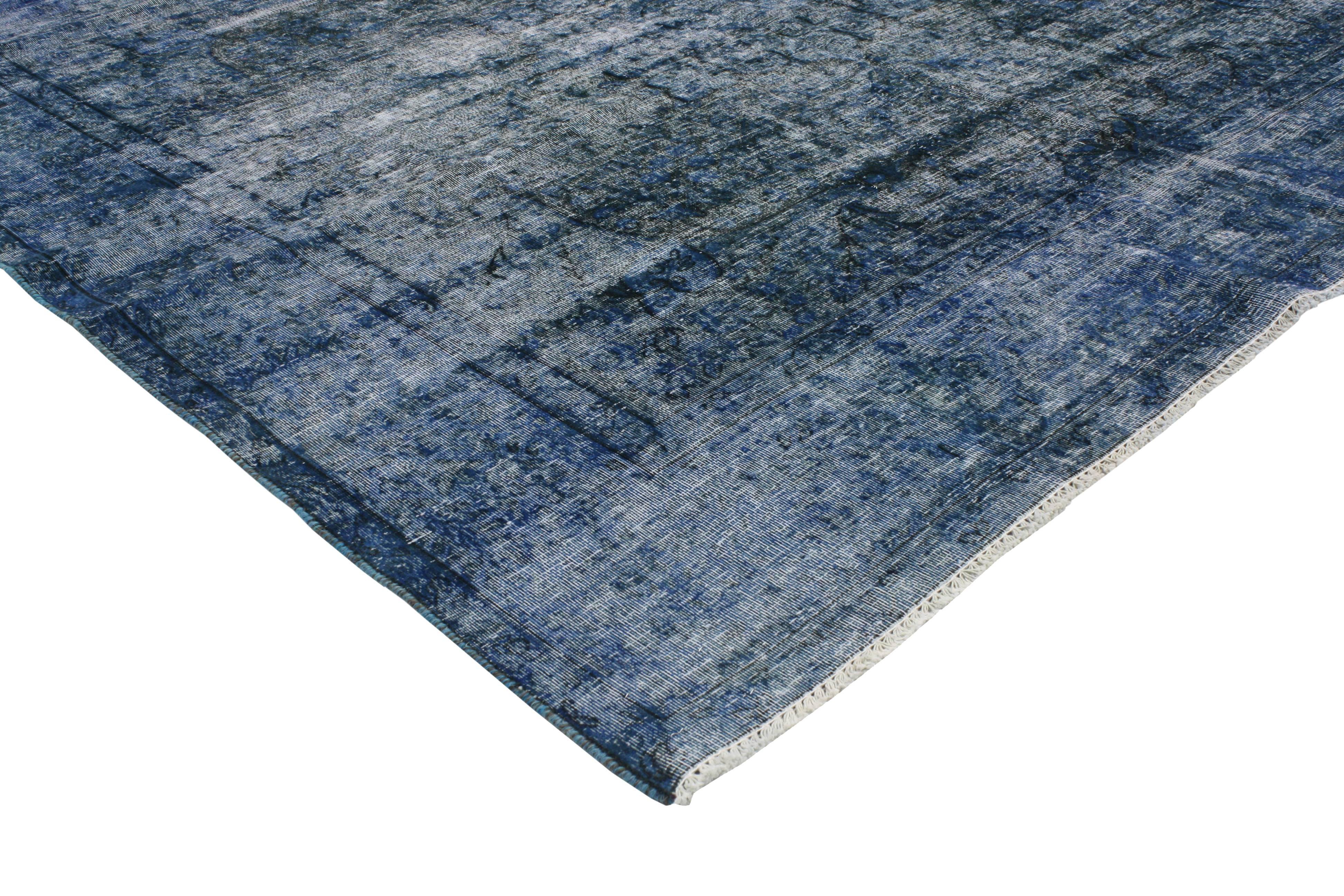 This beautifully distressed and overdyed blue rug features a modern Industrial style. Saturated with variegated shades of blue bring a tranquil yet modern presence when combined with its impeccable and simplistic style. The intricately distressed