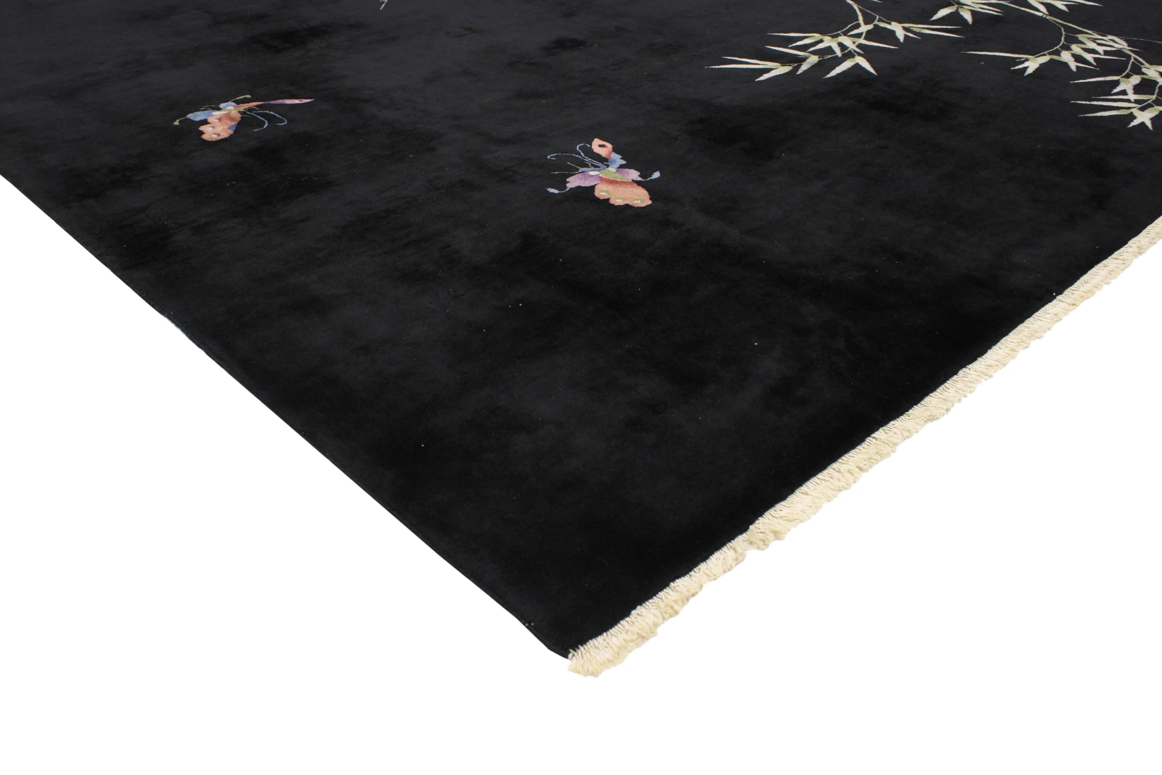 Revive your space with this 1920s Chinese Art Deco rug. Two butterflies float across the black field happily fluttering around the bamboo tree. True to ancient Chinese history, butterflies symbolize young love and legend has it the butterfly also