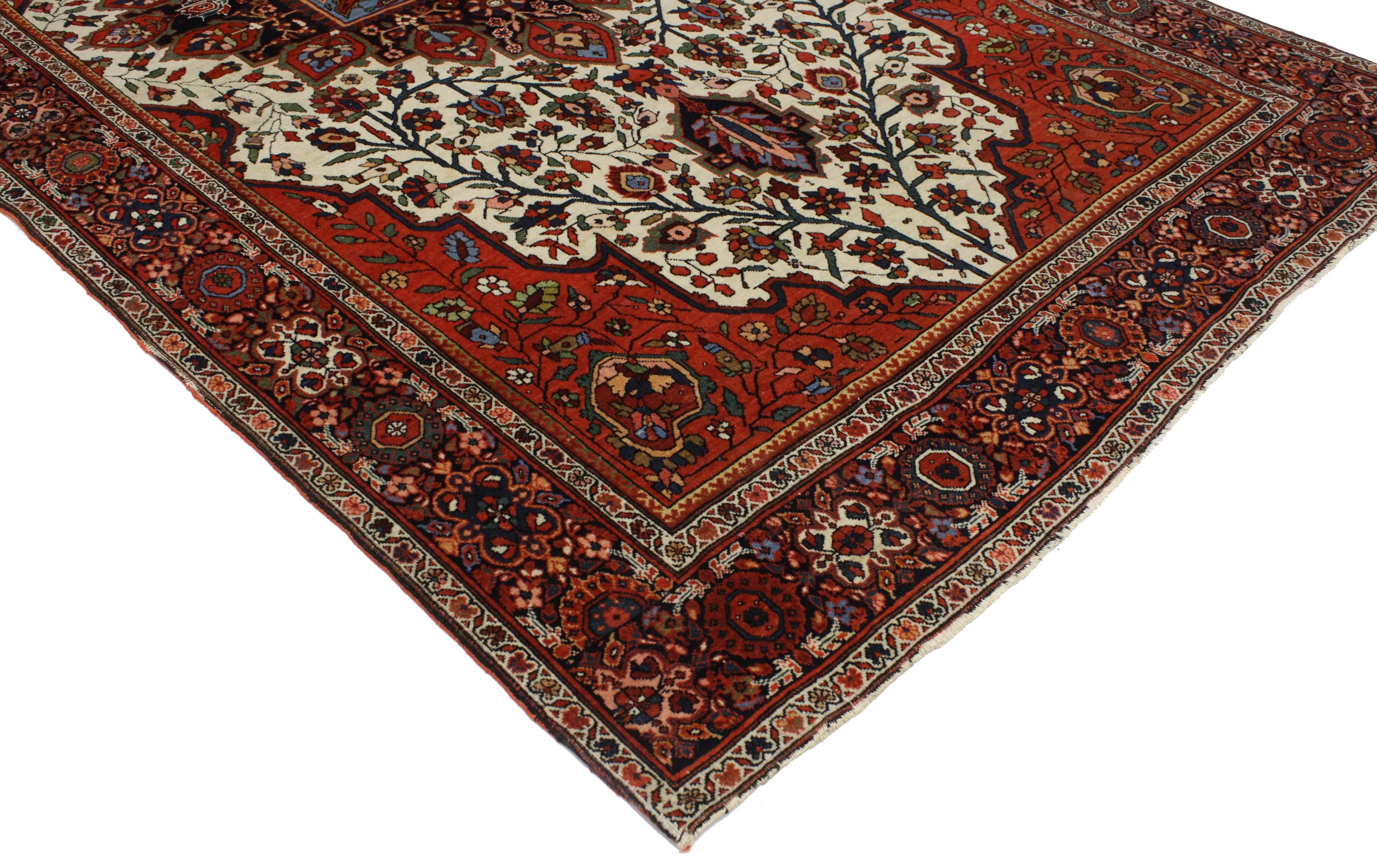 This highly desirable antique Persian Sarouk Farahan rug features an intricate center medallion with modern style. A traditional color palette illuminates its lively, composition. The ornate medallion is surrounded by geometric motifs and vine