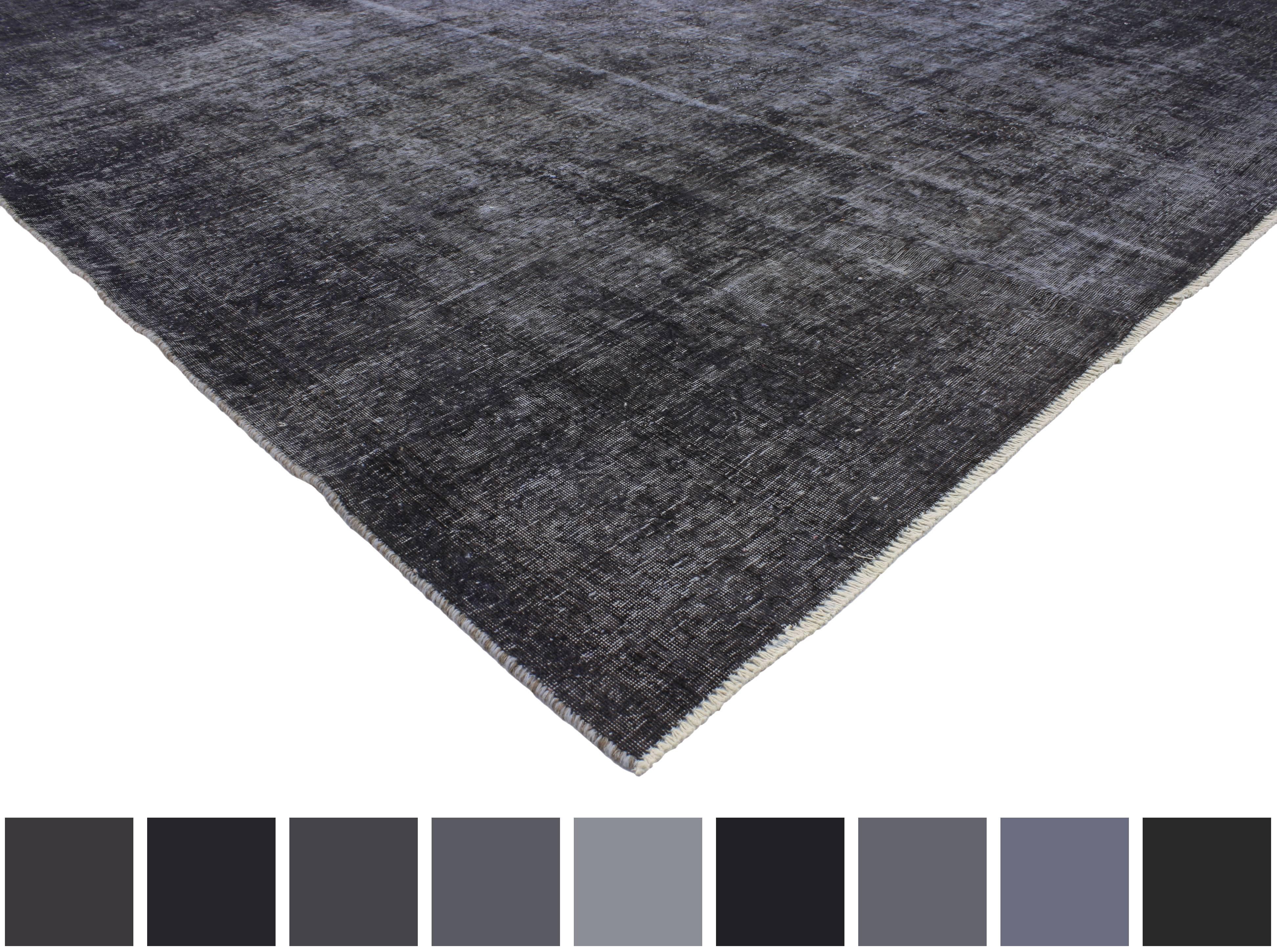 76821 Distressed Antique Persian Charcoal Overdyed Rug with Modern Industrial Style 09'06 X 12'00. Defined and raw combined with luxe utilitarian appeal, this distressed overdyed antique Persian rug goes beyond the boundaries of design with