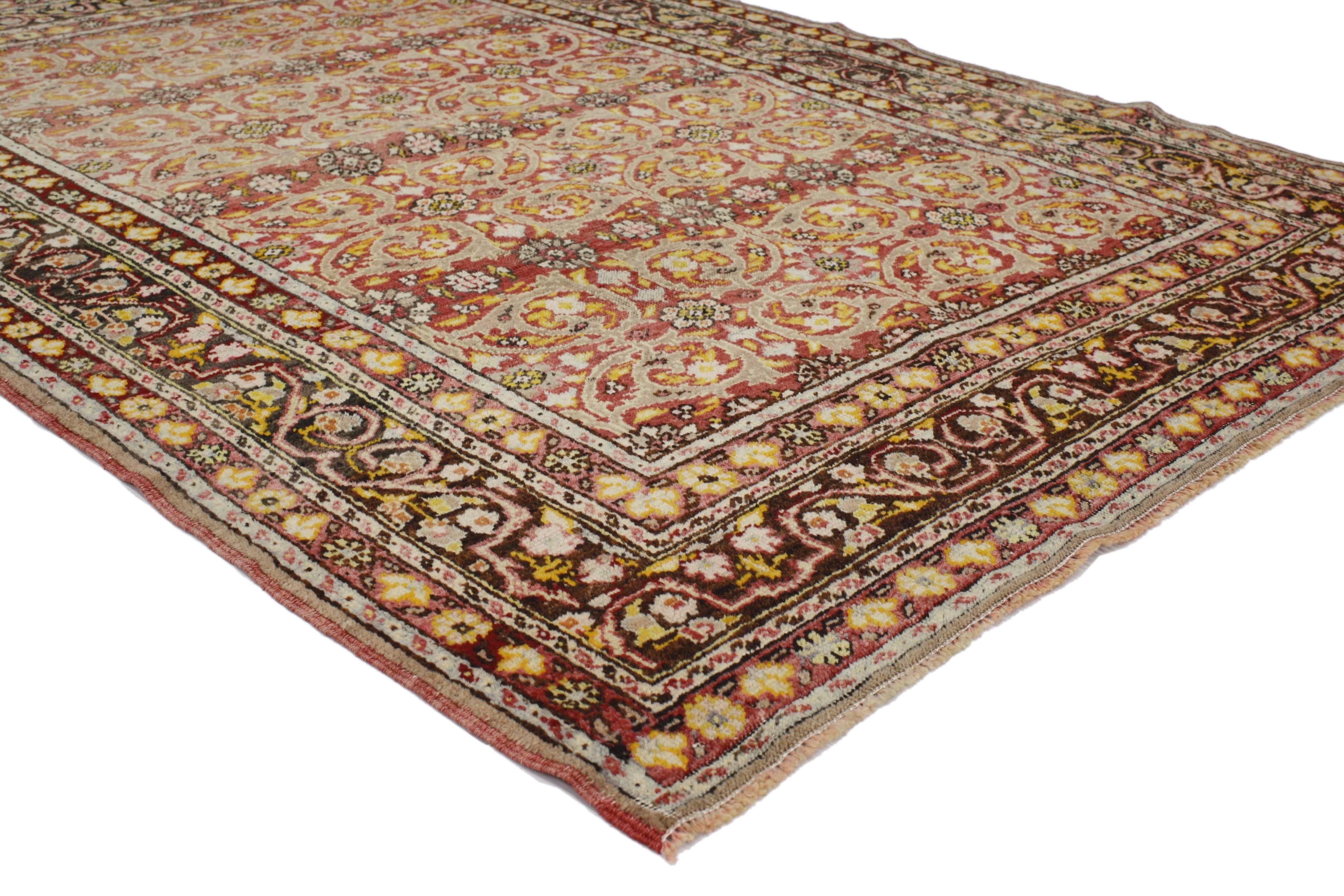 This vintage Turkish Oushak rug with traditional style has many layers that perform well together. The allover design features arabesque vine scrolls and geometric florals surrounded by a complementary border. Rendered in variegated shades of red,