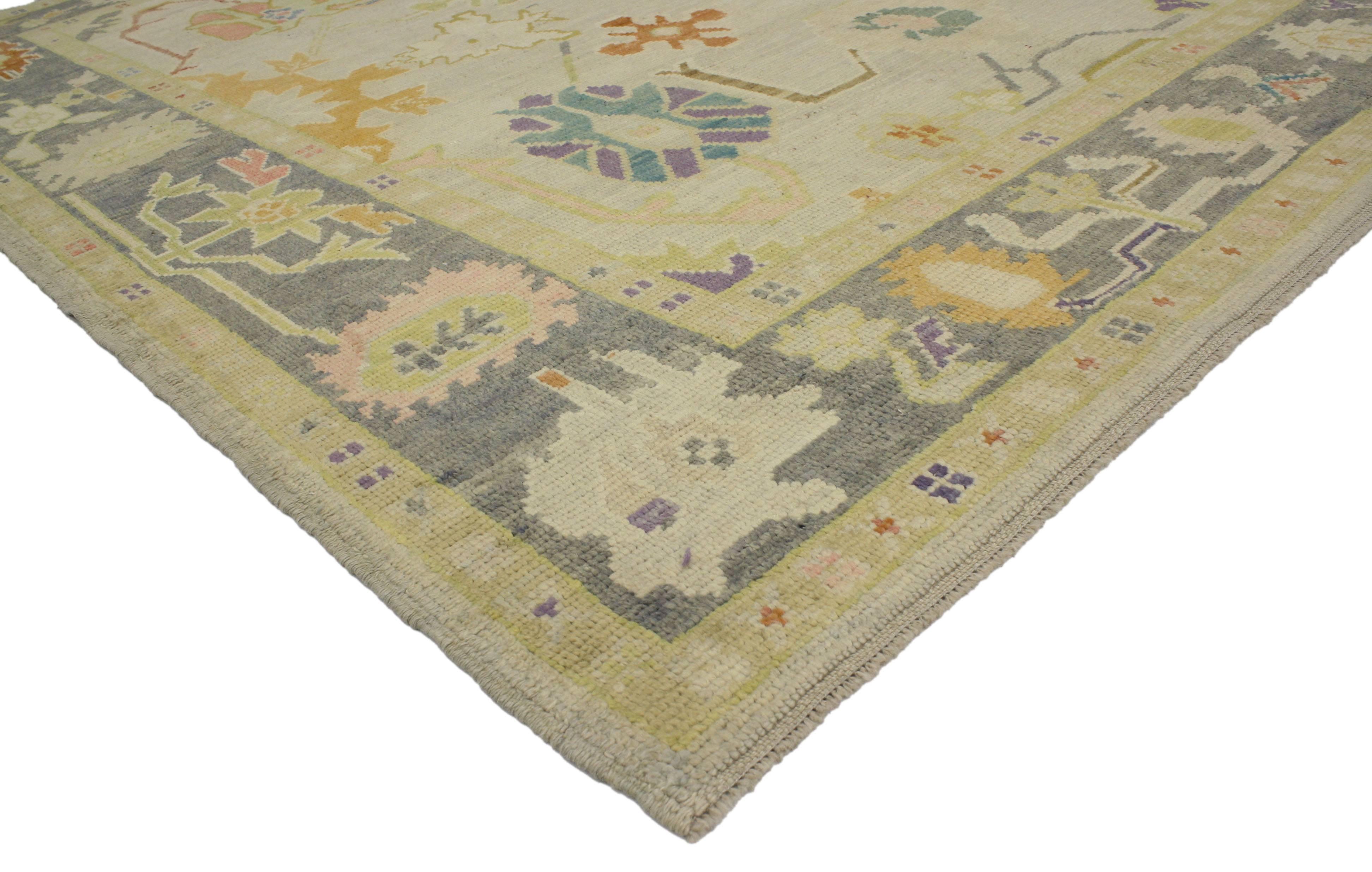 Highly stylish yet tastefully casual, this contemporary Turkish Oushak rug with pastel colors and tribal boho chic style is ideal for nearly any fashion-forward home. This timeless Oushak design has been given a twist to effortlessly accompany