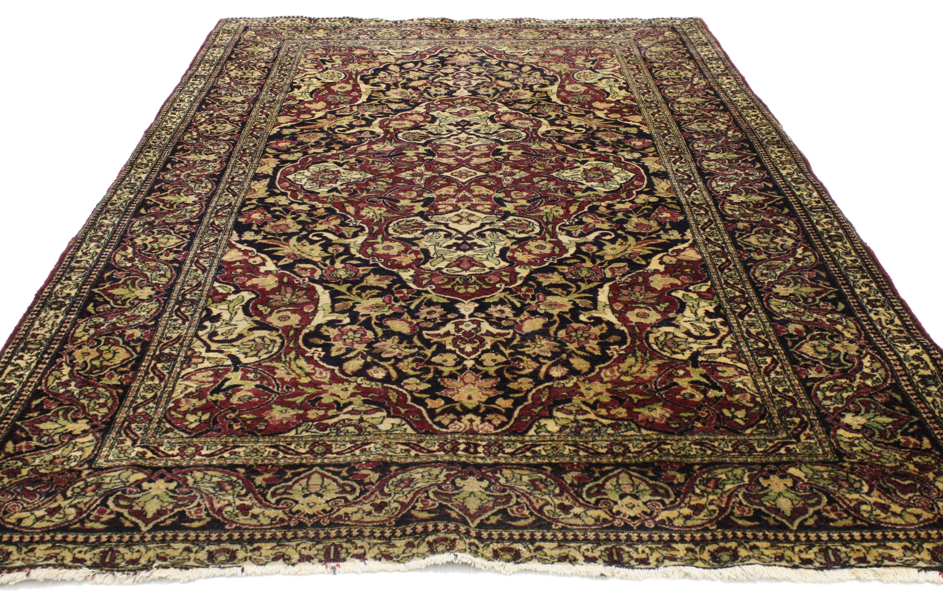 From casual elegance to fresh and formal, relish the refinement as this antique Persian Kerman rug with traditional style creates a timeless design. Its dark colors evoke an air of warmth and comfort with a classic design aesthetic. A grand