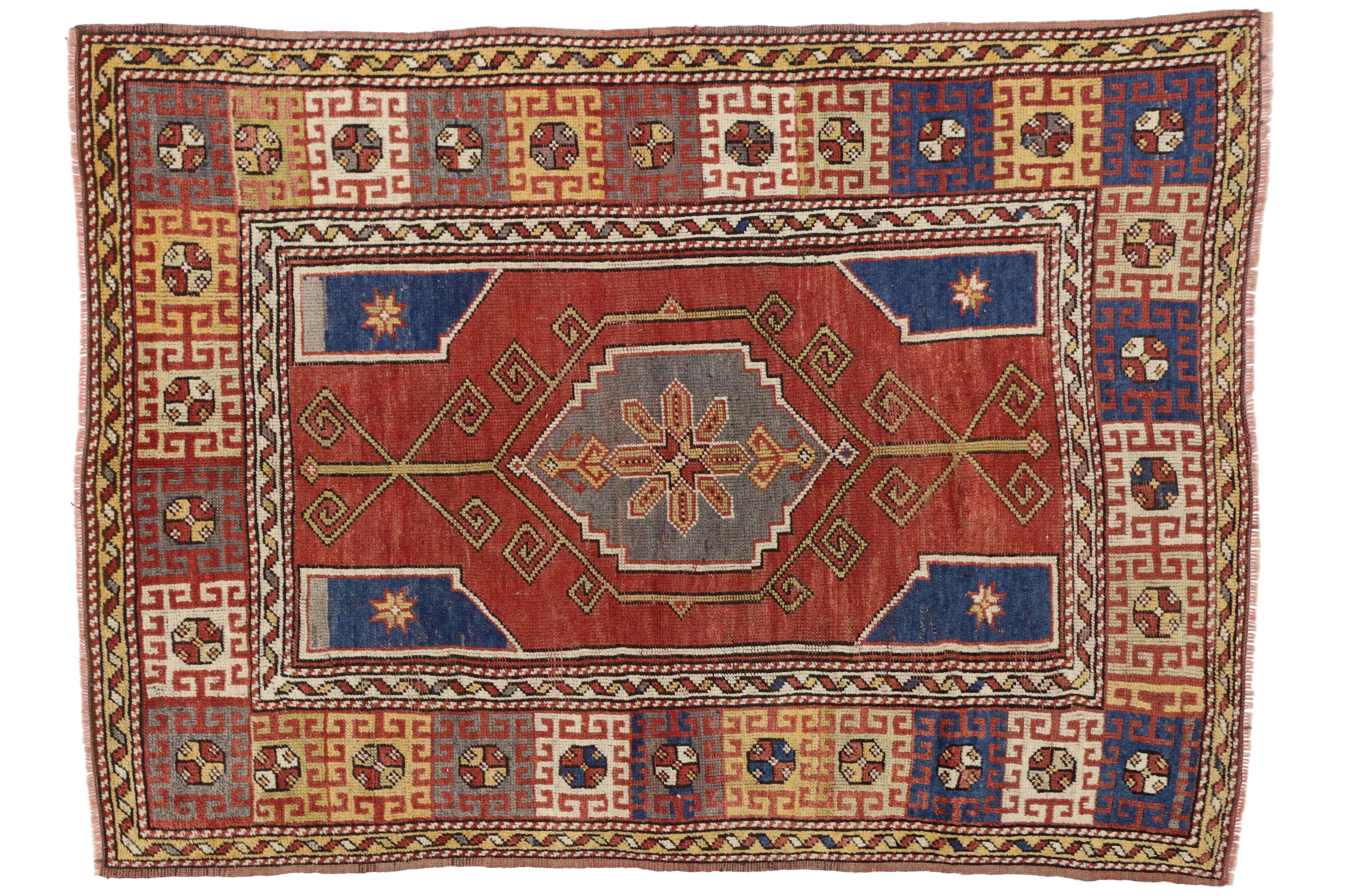Vintage hand-knotted wool Turkish Oushak rug with modern tribal style featuring a hexagon shape center medallion in an abrashed brick red field with blue quarter panels surrounded by a geometric border. Detailed with fine contrasting outlines, every