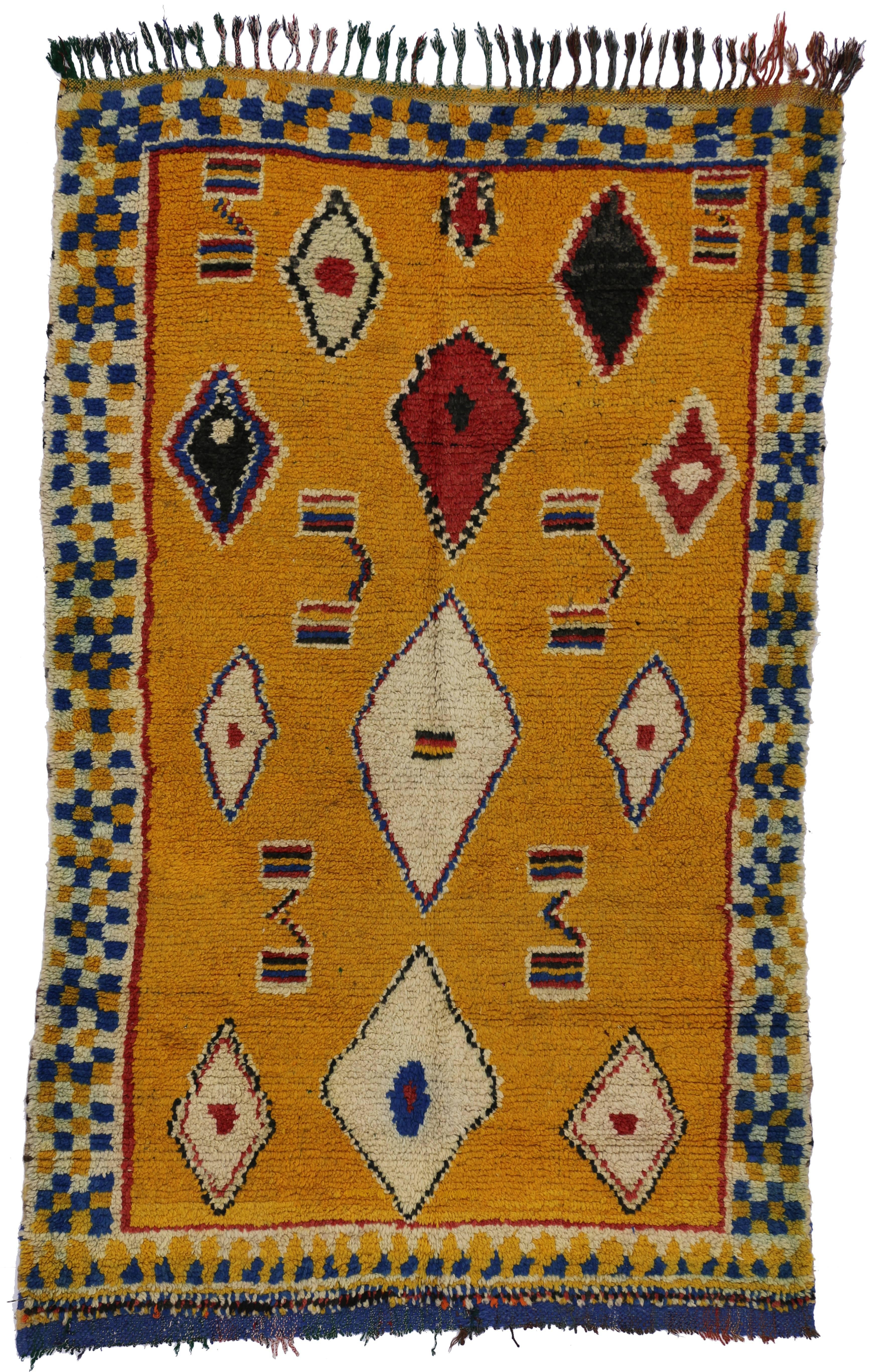 With its diamond protection motifs and vivid Saffron Turmeric colored field, this Berber Moroccan rug is believed to symbolize eternity while protecting the human spirit from negative energy and shielding the human body from the elements. The hints
