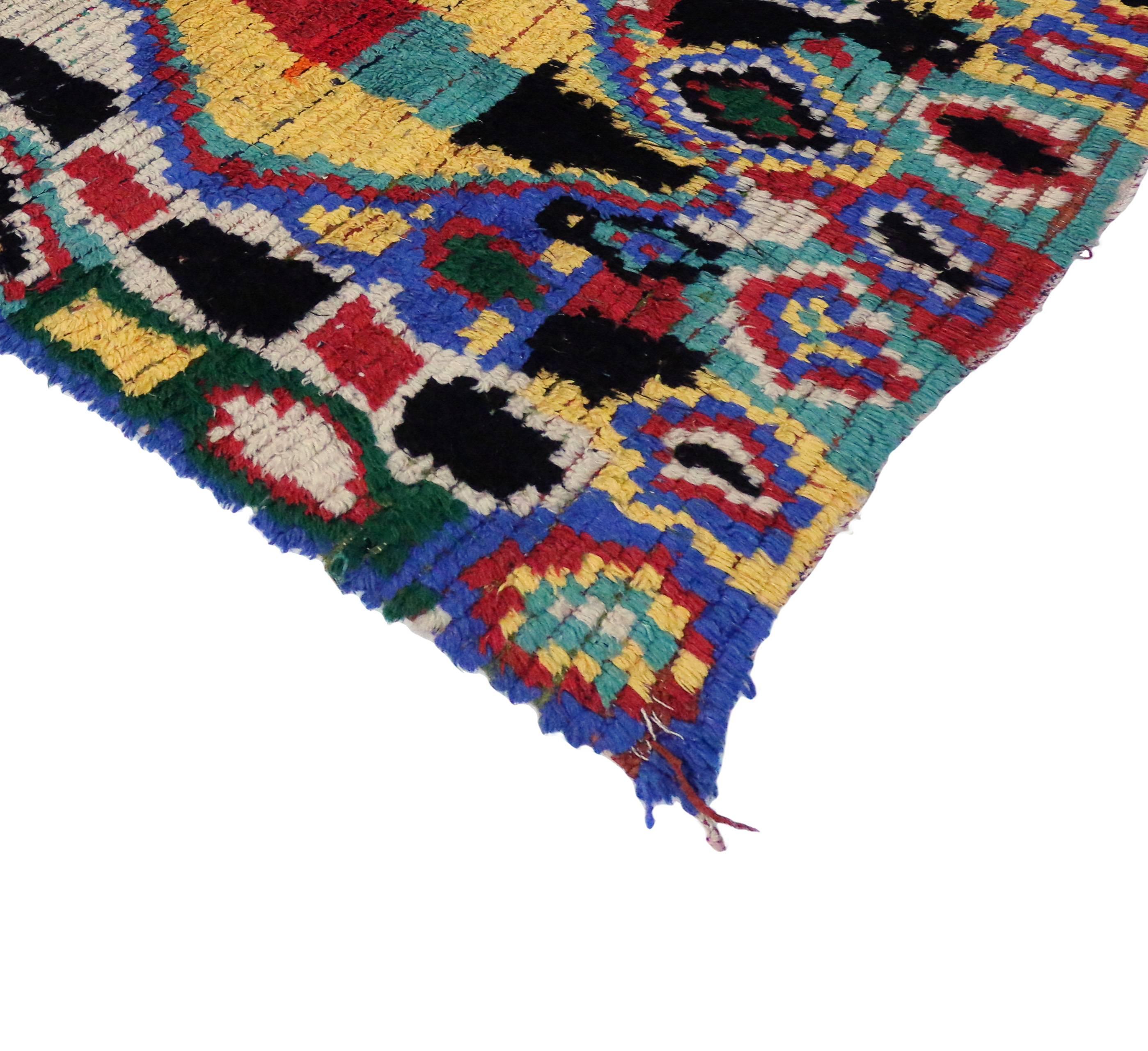 Impeccably woven from the Azilal region of the High Atlas Mountains of Morocco, this vintage Berber Moroccan rug features a contemporary abstract design. Showcasing bold colors and the weaver's creative imagination, this Berber Moroccan rug displays