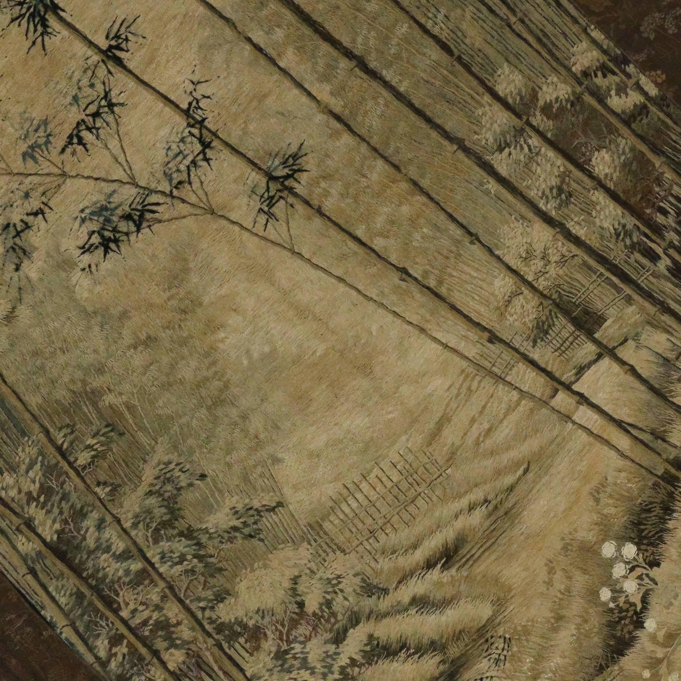 Dating from the 1900s, this is one of the most magnificent pieces of antique Chinese silk tapestries. Rendered in an elegant, Classic style, this stunning antique Chinese embroidery depicts a traditional verdure scene. The refreshing variegated