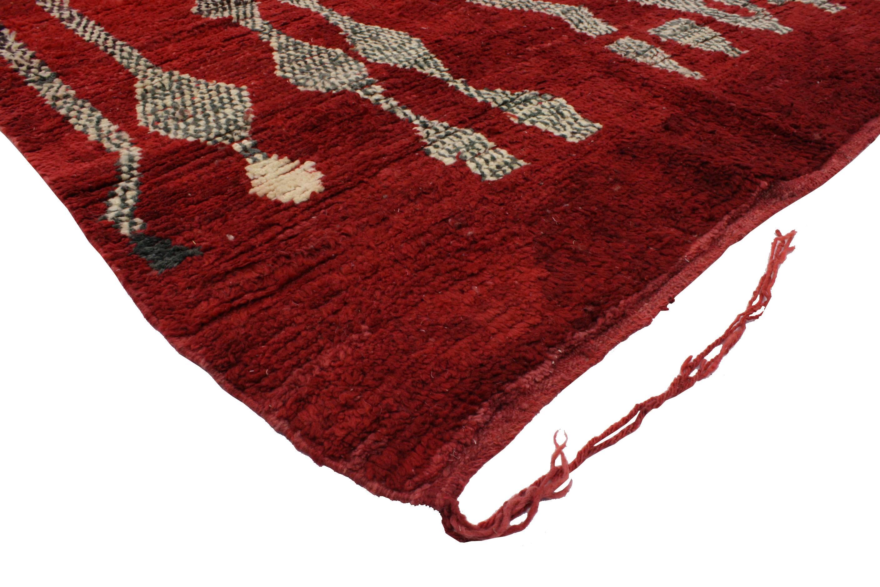 Adding a chic Bohemian flair to timeless tribal design, this eccentric Moroccan rug will create a truly tempting look for nearly any space. Exploding with a vibrant color palette of red, pink and green, the black and white accents contrast nicely on