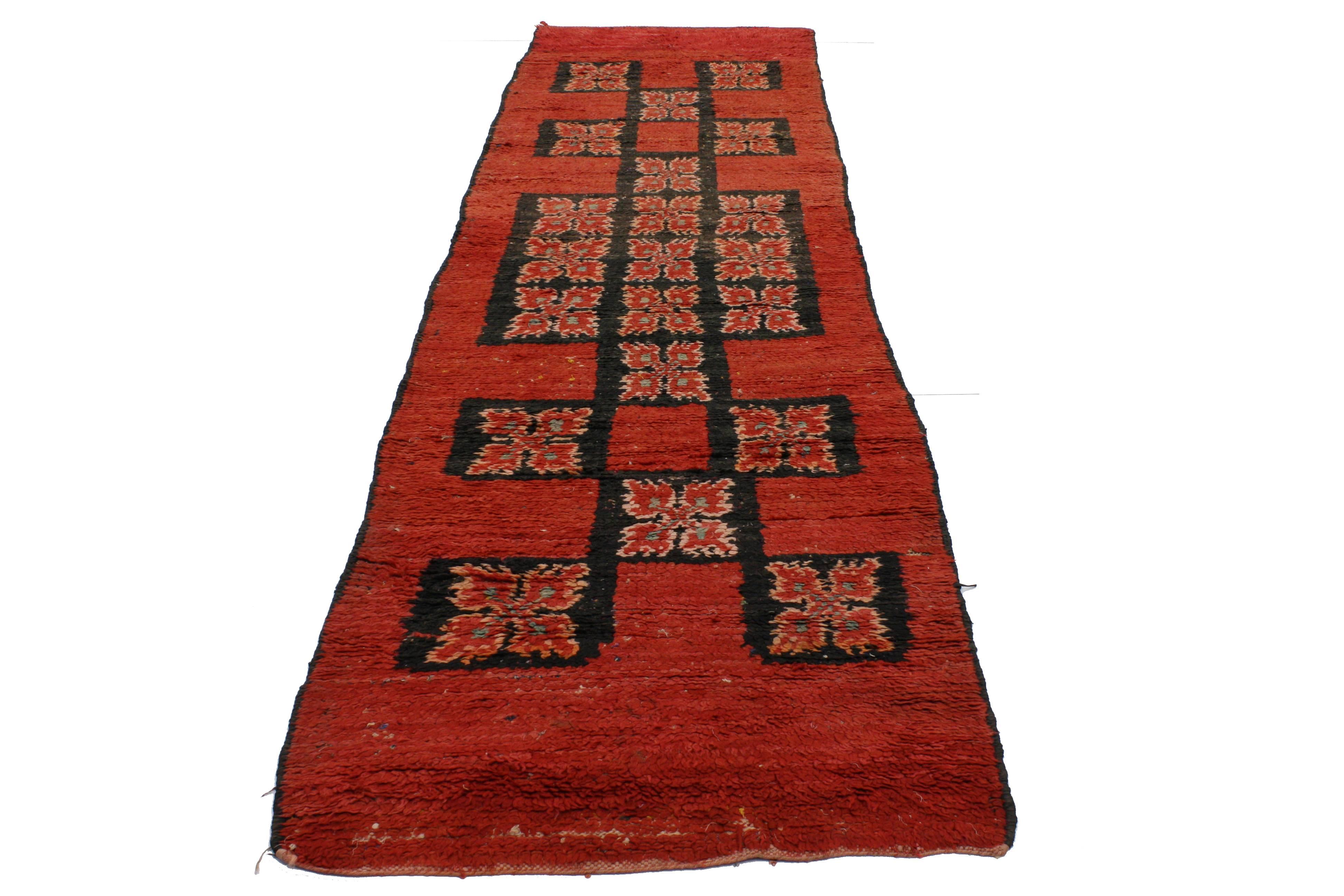 20253 Vintage Berber Moroccan Runner with Mid-Century Modern Style. This hand-knotted wool vintage Berber Moroccan runner features an open red abrashed field composed of black geometric square motifs stacked along the center. With its edgy elements