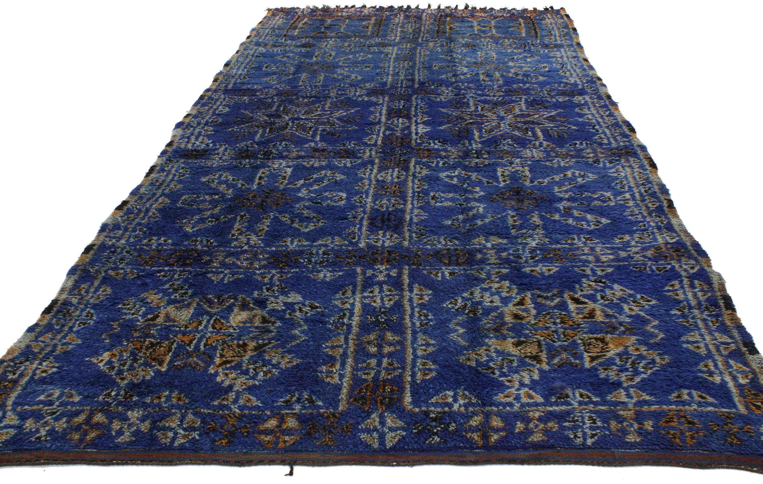 Featuring a saturated palette of cobalt blue, this plush piled vintage Moroccan rug by Beni Ouarain carpet embodies a youthful and whimsical vibe with its tribal style and Berber Tribe history. Features ancient tribal motifs enclosed in individual