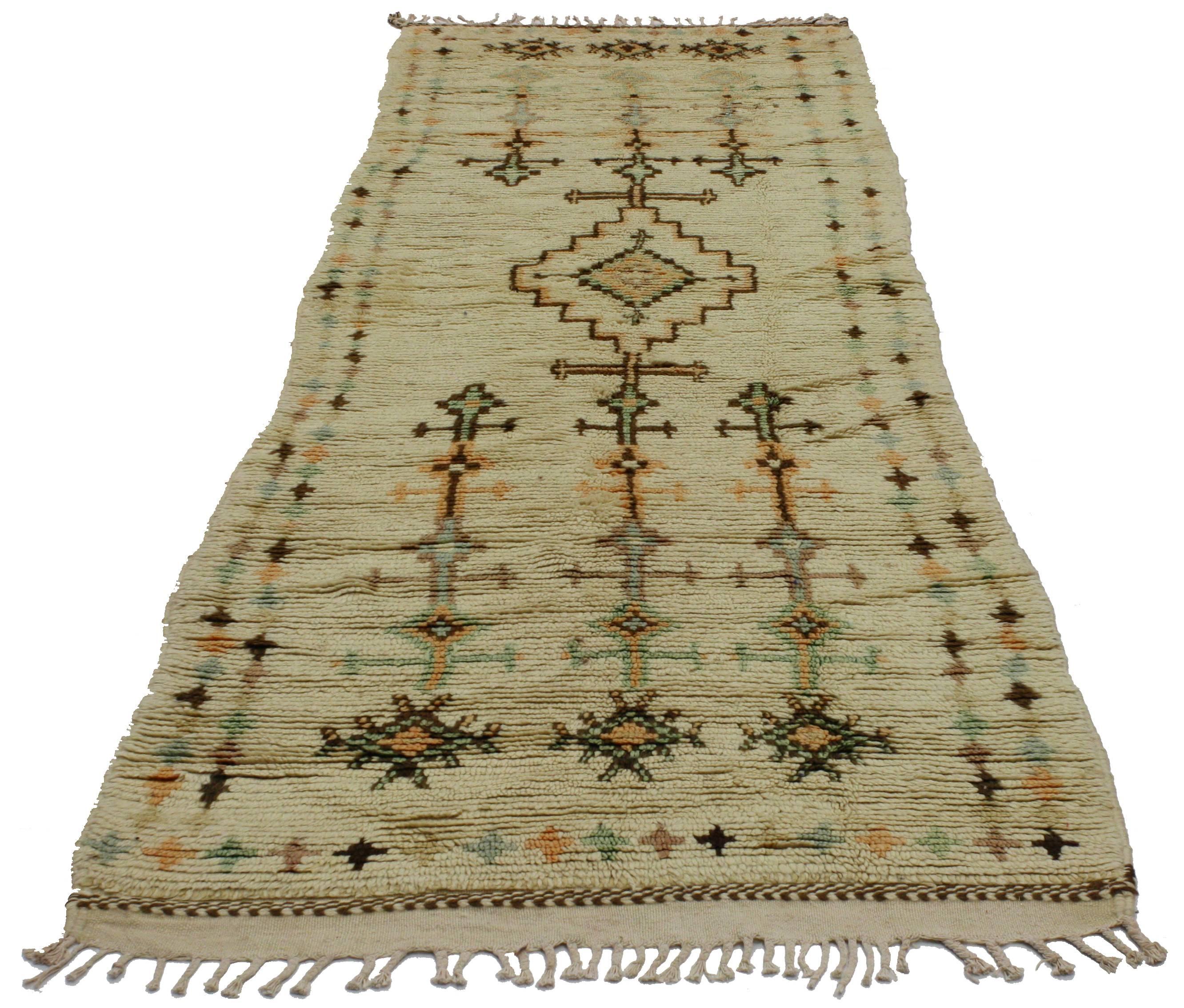 Handmade in Morocco, this fascinating Berber Moroccan runner with tribal design in light colors features a beautiful assortment of geometric motifs arranged in a well-balanced composition. With its vintage vibes and tribal facade, this Moroccan