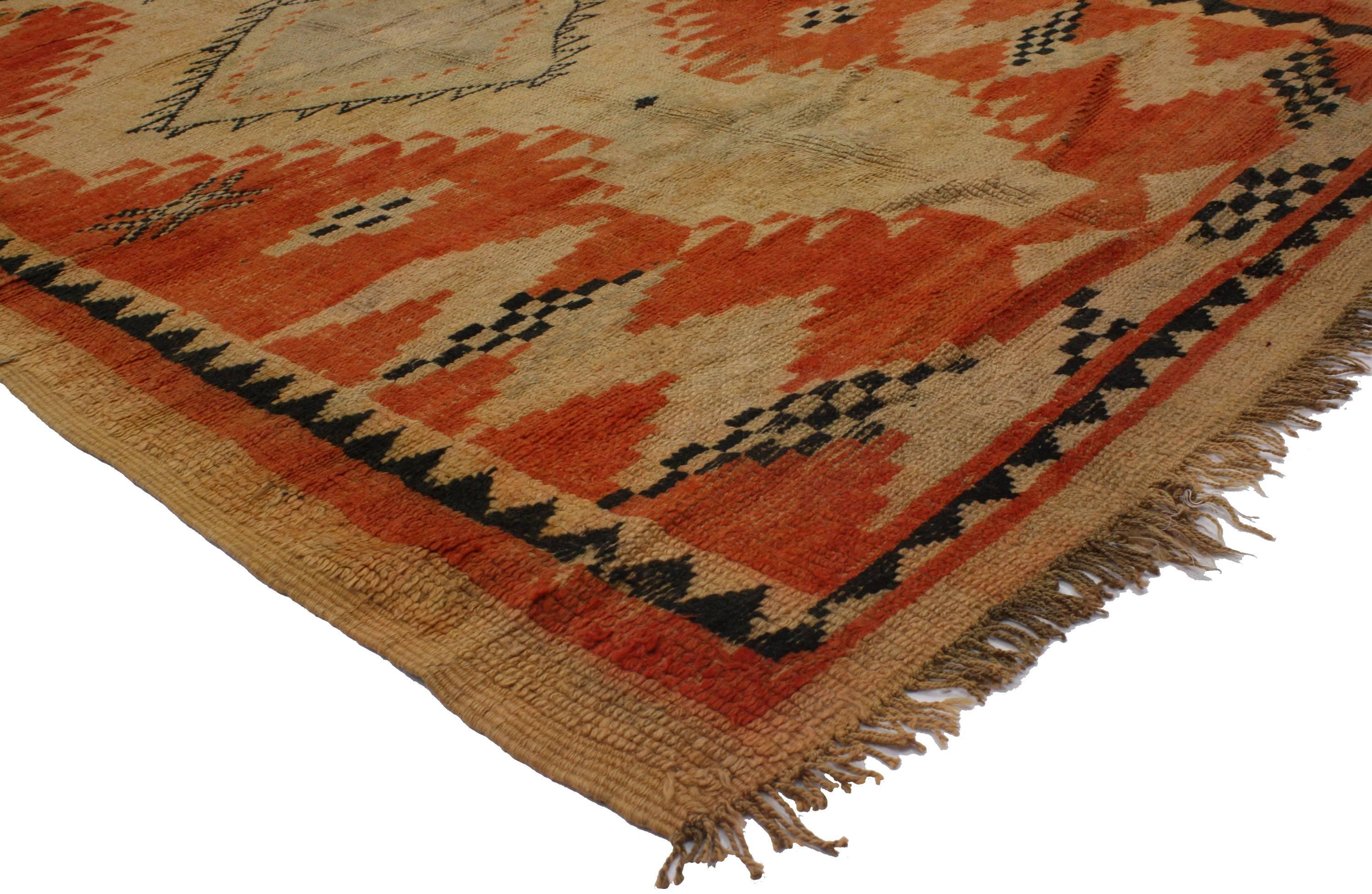 This beautifully composed vintage Berber Moroccan runner with tribal design was handmade by the Berber Tribes of Morocco in the mid-20th century. With its distinct tribal style and characterized by a beautifully abrashed field, this Moroccan runner