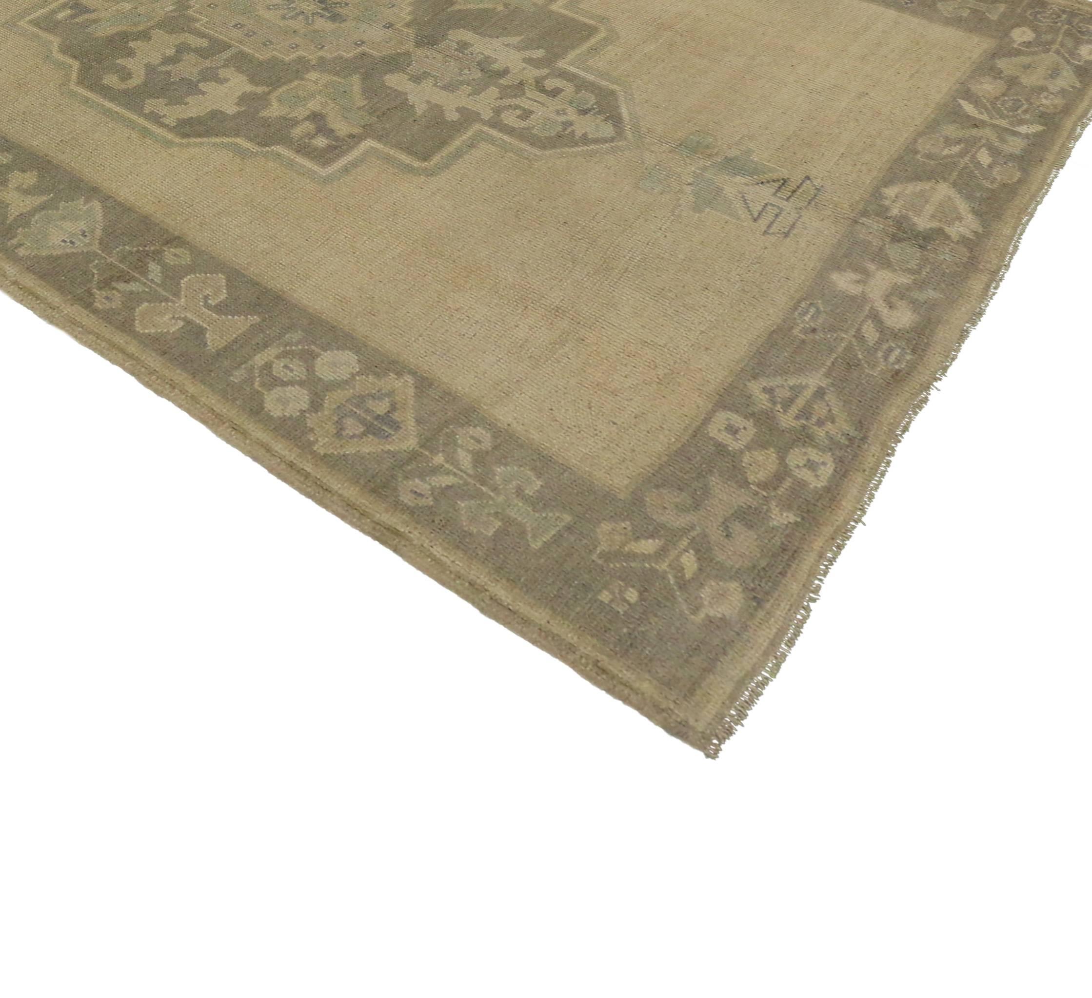 This stunning vintage Turkish Oushak carpet runner features a modern style in muted colors. Take a timeless, tailored design, mix in a dash of history and time-softened colors to get this fresh look that’s as comfortable as it is chic. Elegant