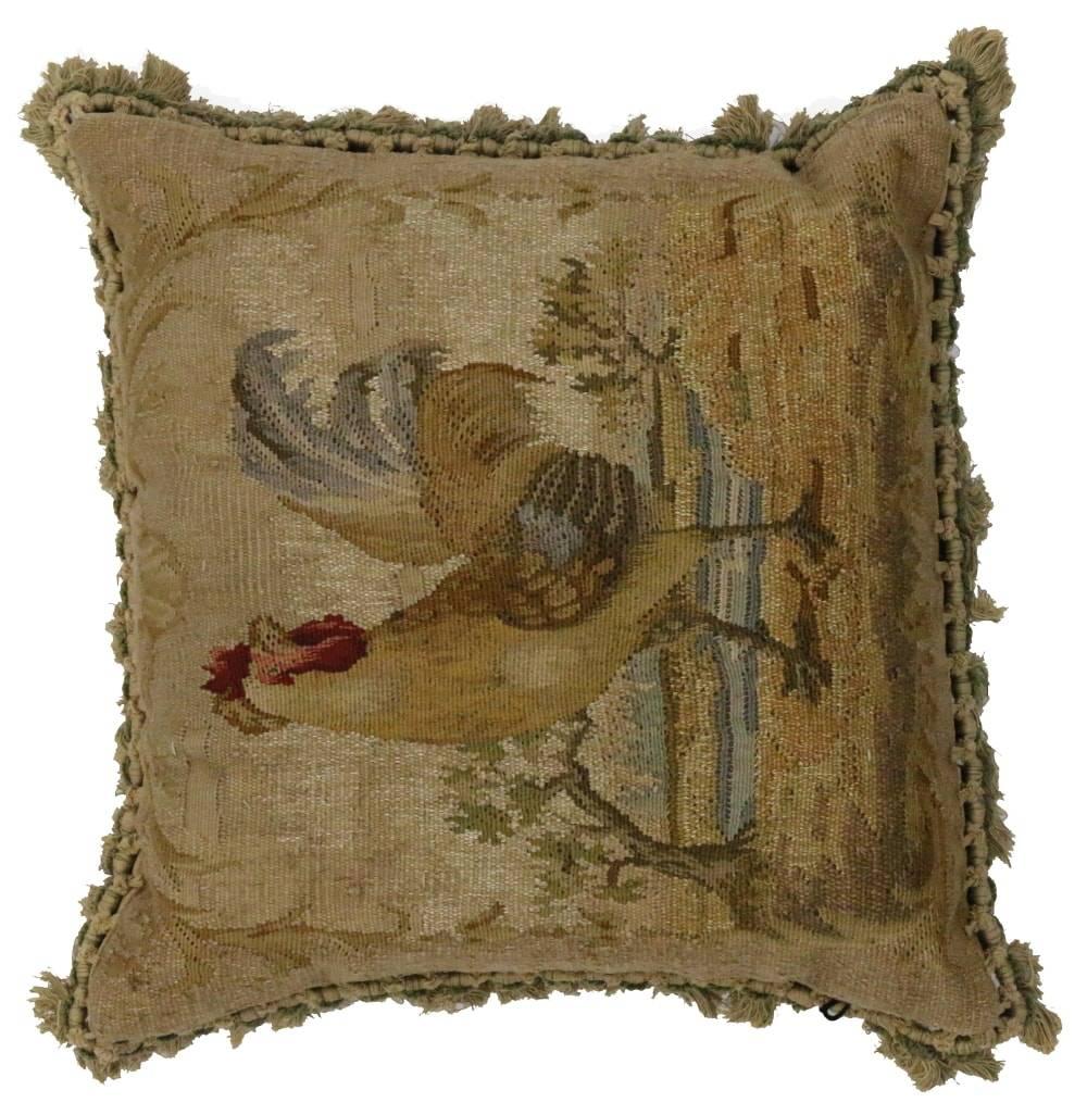 Add country charm and French Colonial style with this late 19th century antique European tapestry pillow with French Passementerie fringe. A decorative scene of a stately rooster enjoying the lakeside and rendered in rich and refined colors ranging