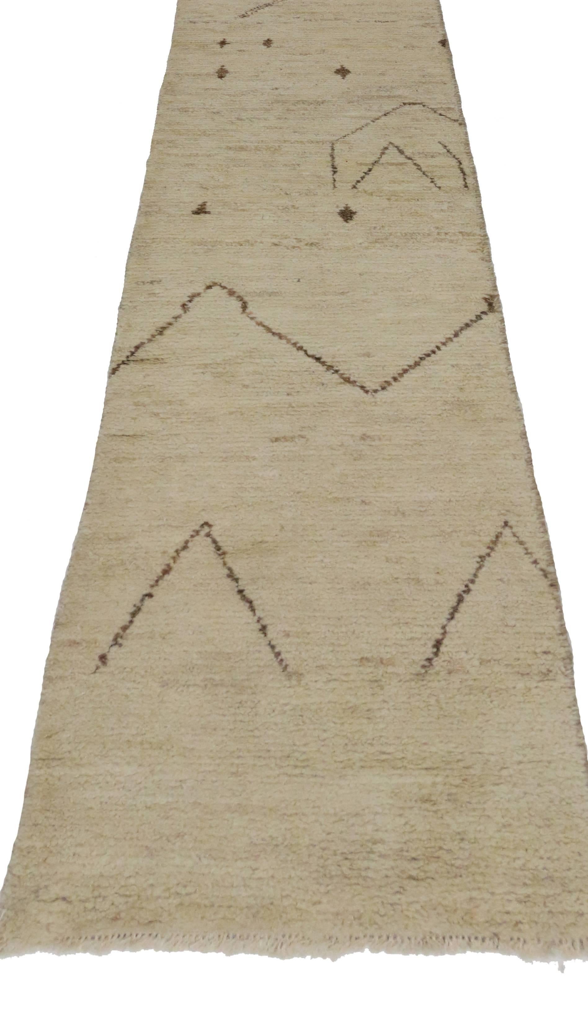 Representing a stylish union of Mid-Century Modern and Tribal Chic, this contemporary Moroccan runner features boho chic style and warm neutral colors. Highlighting its Primitive charm, the tribal designs are culturally significant. The symbols are