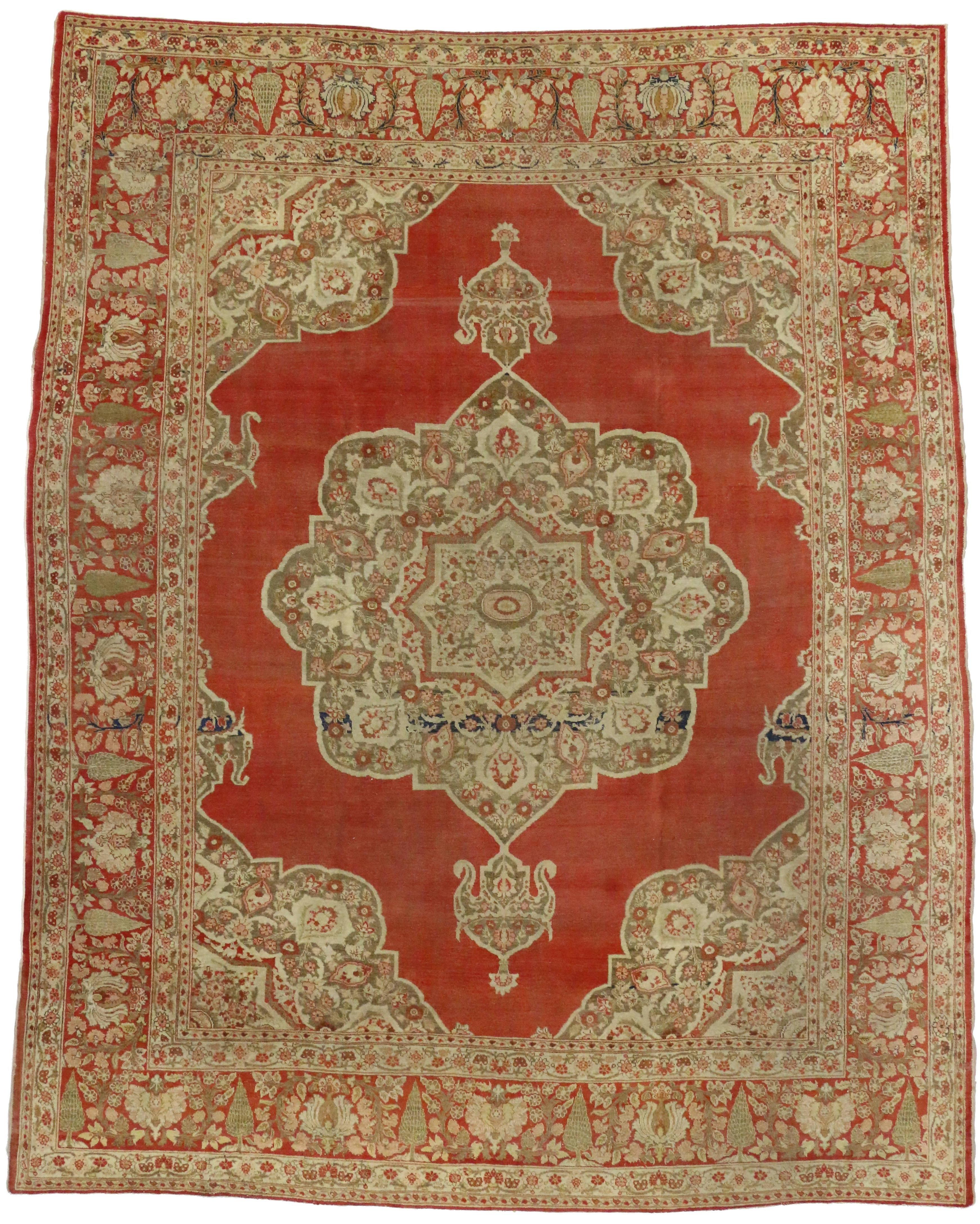 74140 Haji Khalili Antique Persian Tabriz Rug with Tudor Manor House Style. This hand-knotted wool antique Haji Khalili Tabriz rug features an eight-point medallion inside a larger size eight-point cusped medallion floating in an open abrashed red