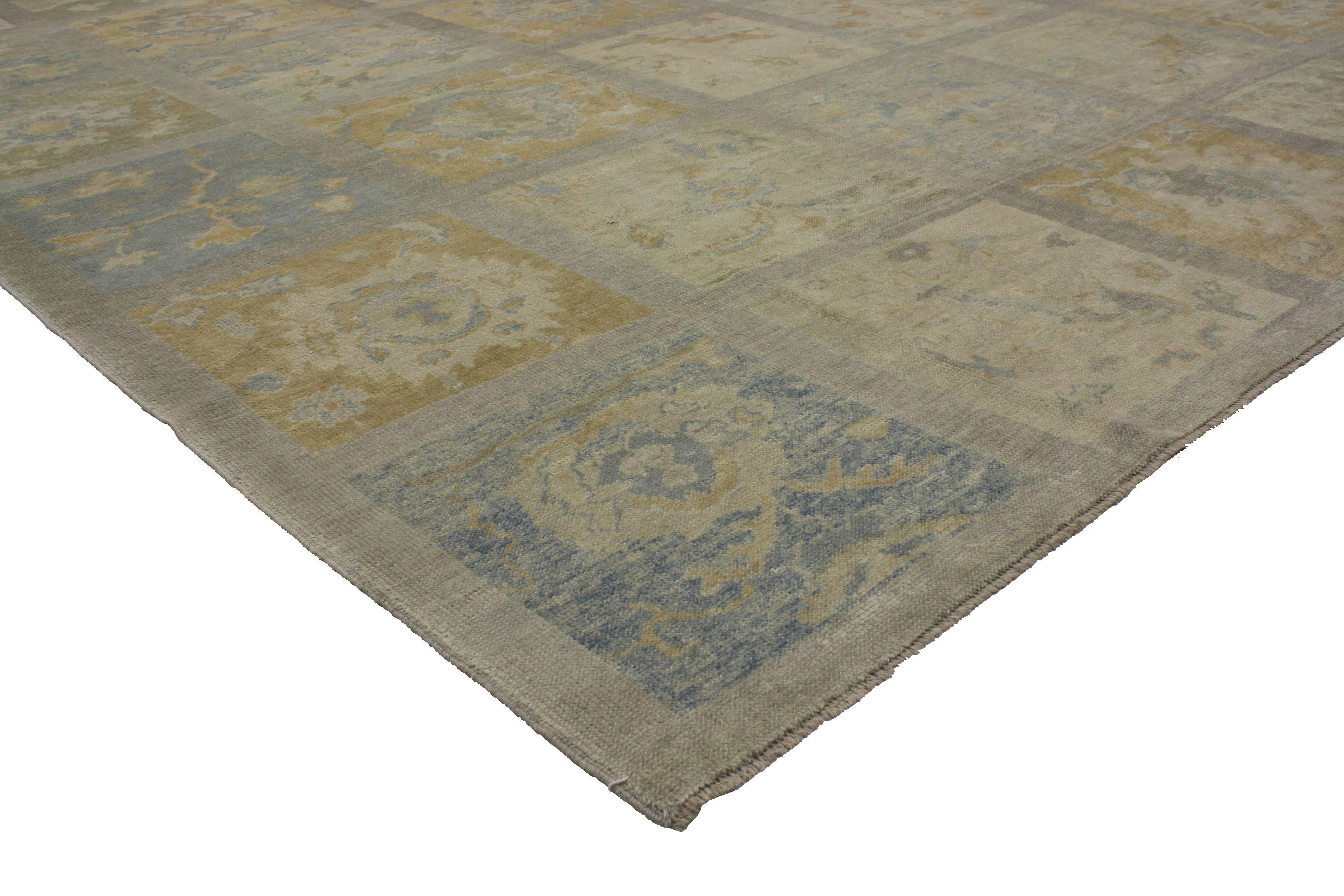 Coastal colors integrated with an intimate patina, modern Turkish Oushak rug features a garden design with a transitional style. Classically composed and boasting a truly magnificent panel compartment garden design, this modern Oushak rug reflects