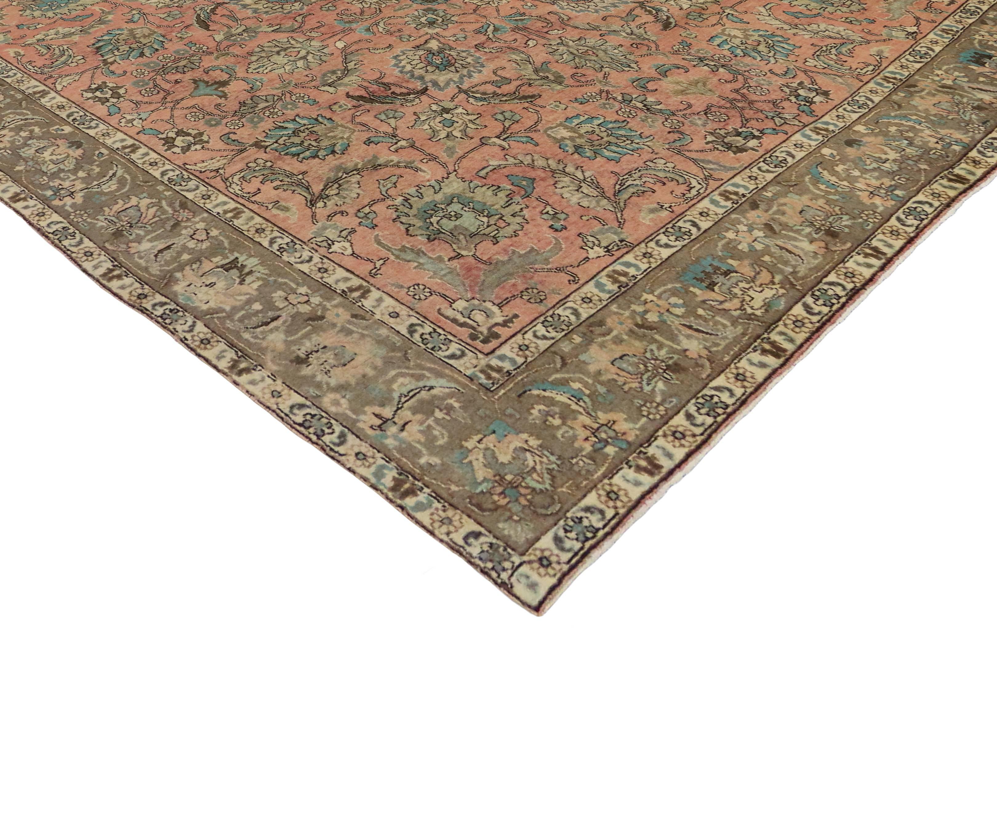 Embodying the highly decorative aesthetic, this vintage Persian Tabriz rug displays a traditional style in light colors. Featuring a tastefully casual presence and sophisticated chic style, the all-over geometric pattern resonates an astounding