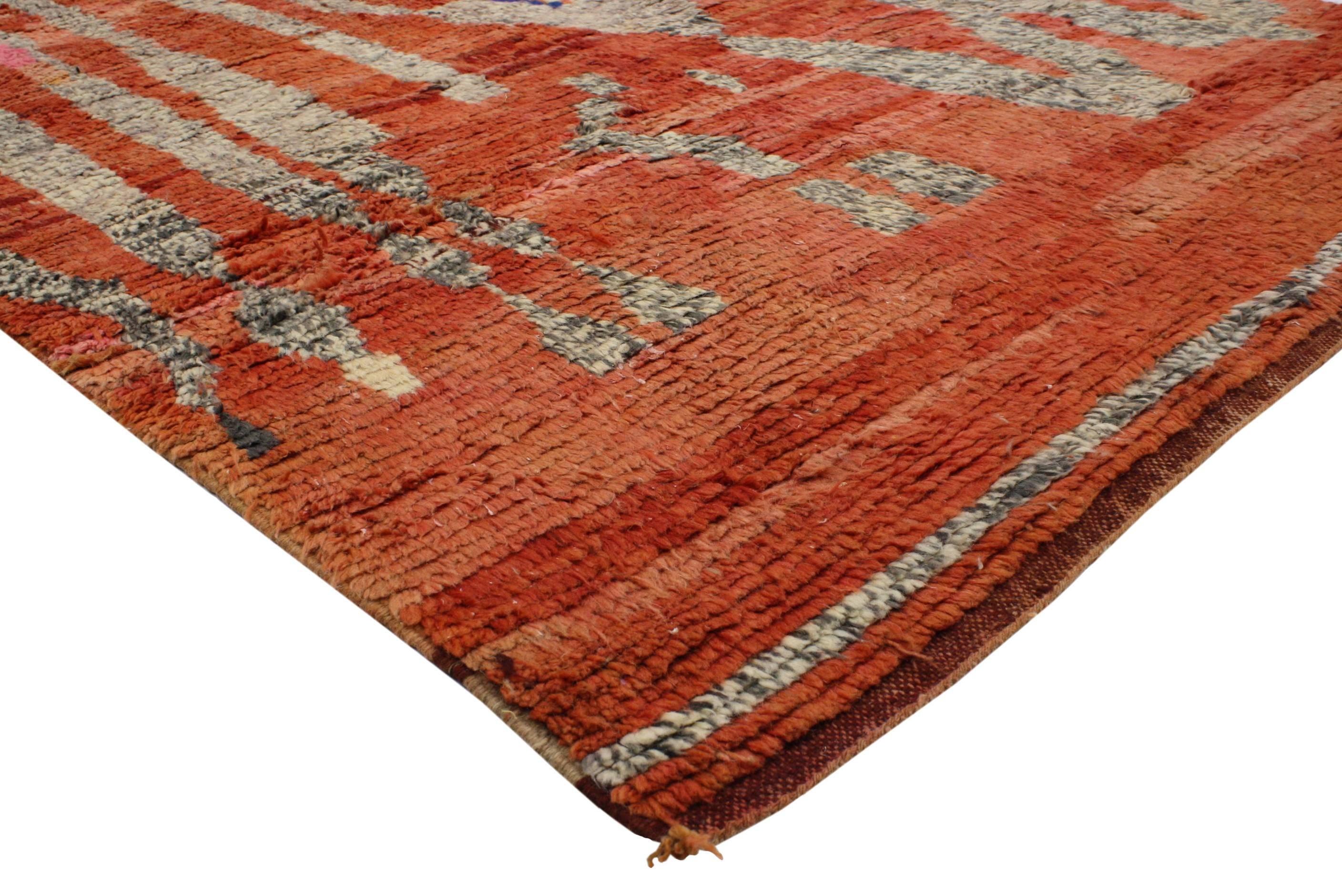 Electrify your space by filling it with color, art and playfulness found in this vintage Berber Moroccan rug featuring abstract Tribal design. Displays a unique and contemporary pattern rendered in orange, blue, gray, beige and cream with a pop of