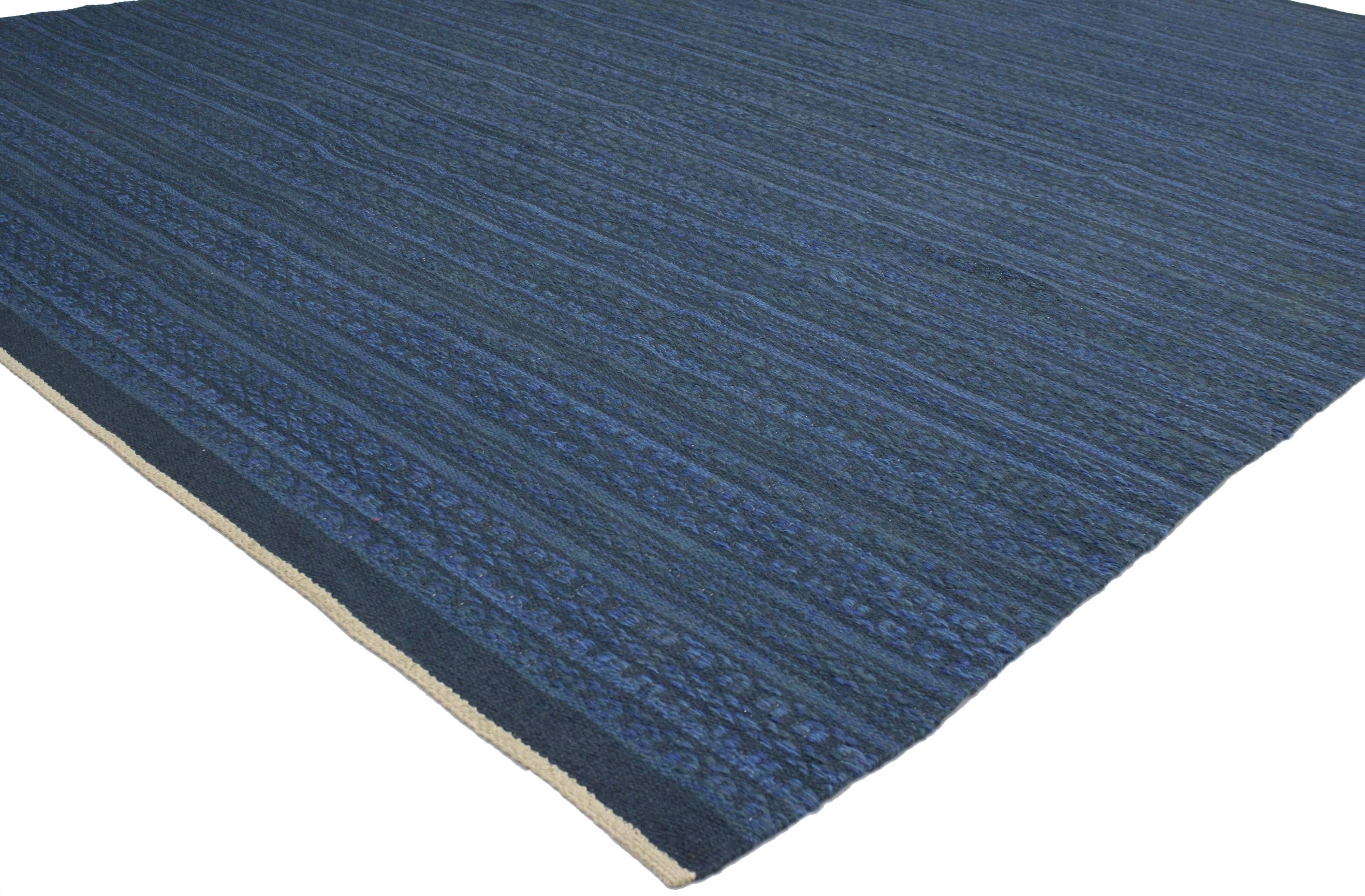 Featuring a traditional modern design highlighting some of the finest midcentury Swedish rugs, this appealing example is influenced by its subtle beauty that is enhanced by its fresh blue color. This vintage Swedish Rollakan Kilim was designed by a