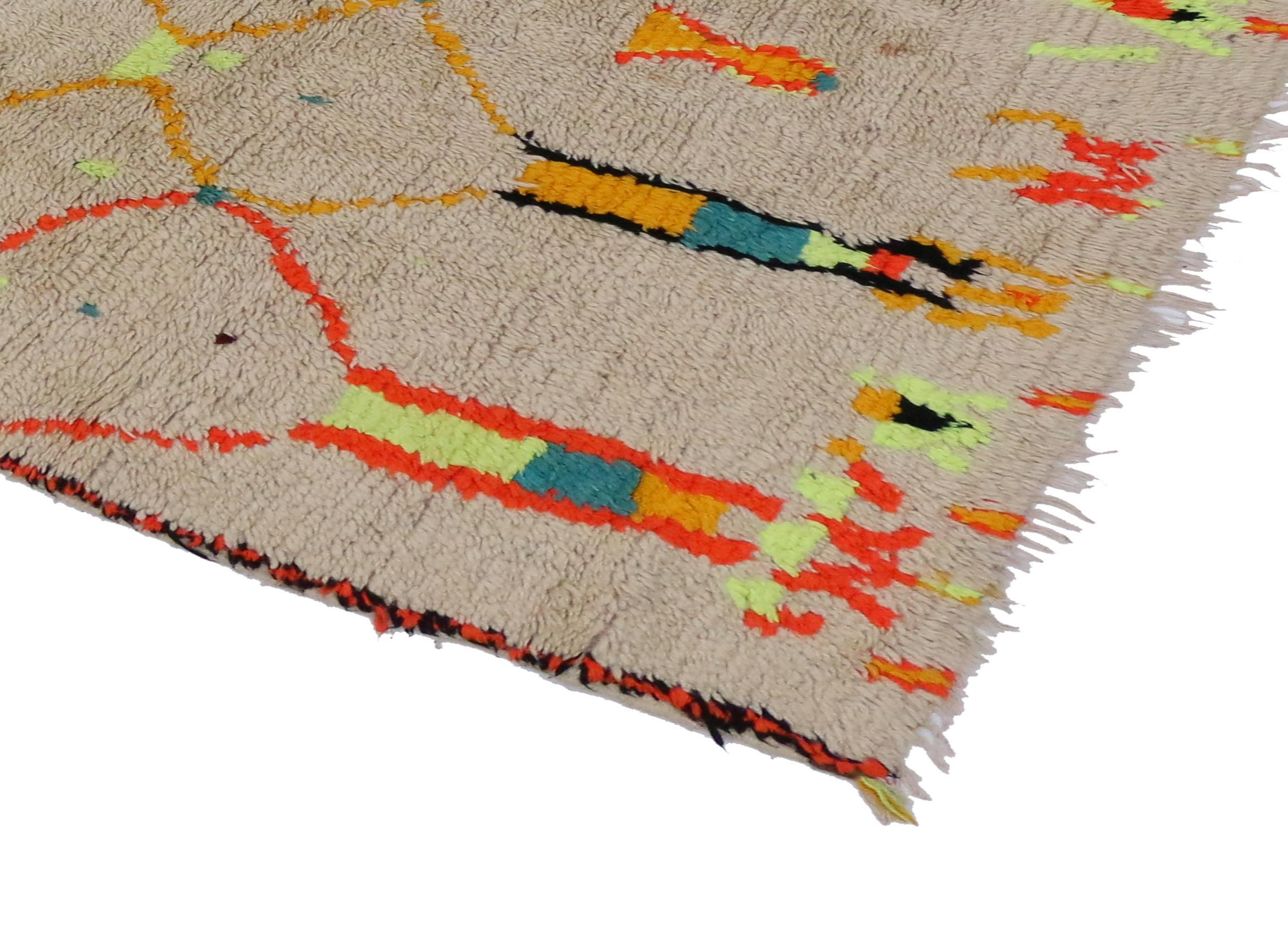 With its boho chic style and primitive charm, this vintage Berber Moroccan runner with modern tribal design conveys a sense of beauty and mystery. Impeccably woven from hand-knotted wool in vibrant colors, this Moroccan rug runner does an excellent