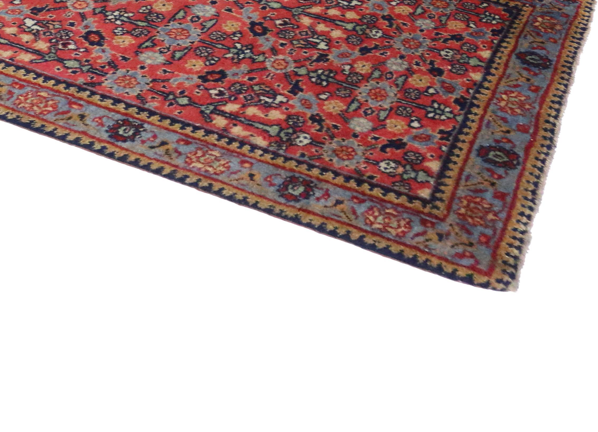 Antique Persian Tabriz carpet runner with modern traditional style featuring an all-over floral pattern in a refined palette consisting of soft red, light blue, dark blue, mint green and tan. Decorative palmettes and the masterful color combinations
