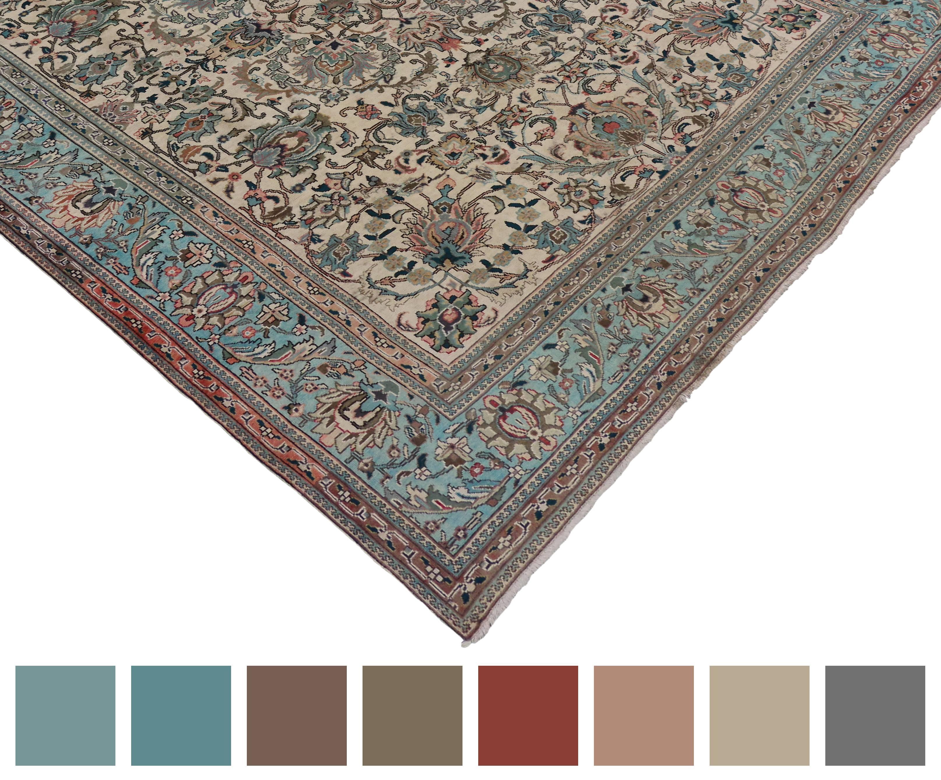 Timeless and refined, this vintage light blue Persian Tabriz rug features a Hampton's Chic style. The vanilla-cream field is surrounded by all-over florals, motifs and arabesque vines abundantly flow creating a well-balanced design. A light aqua