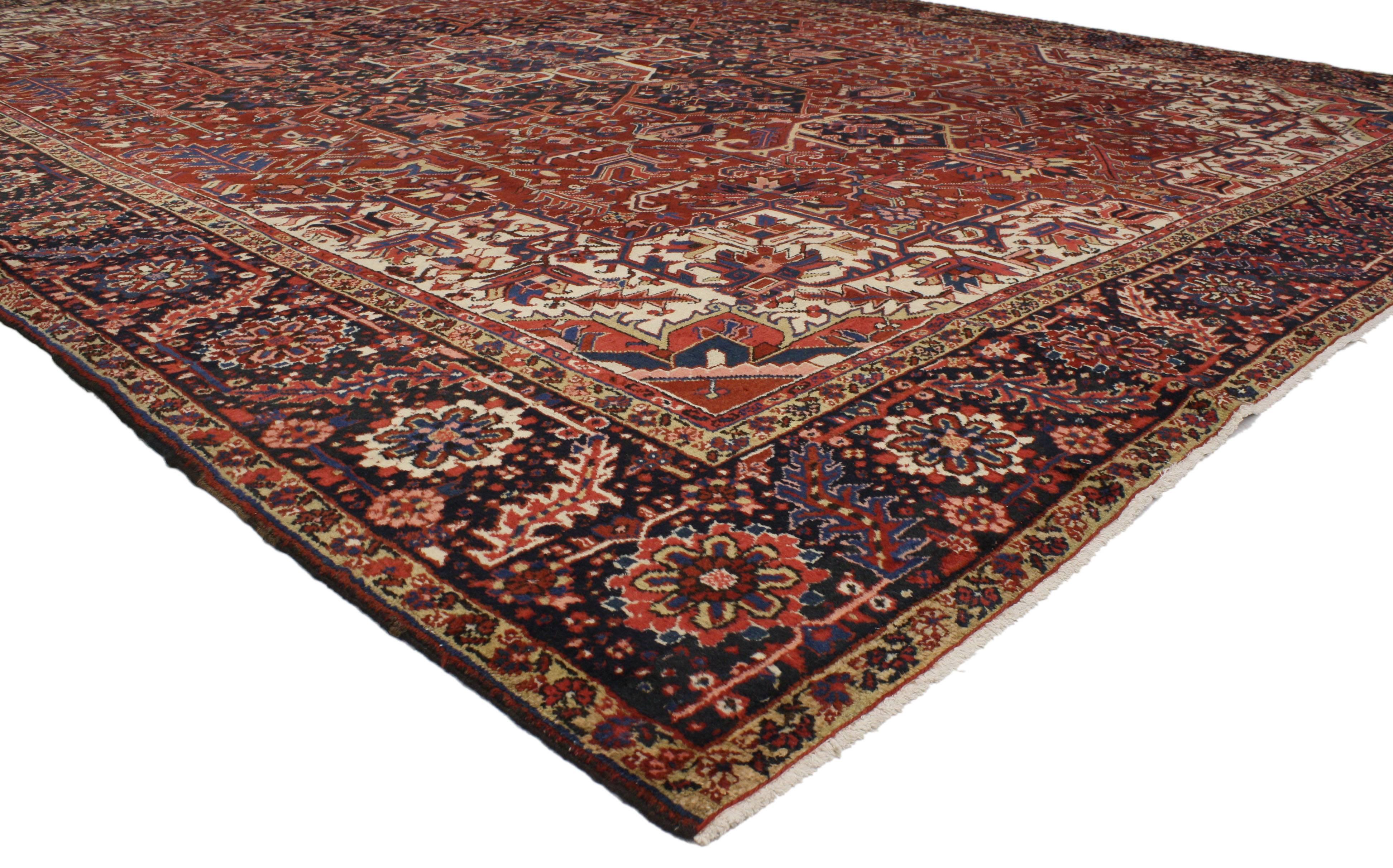 52151 Antique Persian Heriz Rug with English Tudor Manor Style. This oversize antique Persian Heriz rug features modern traditional style with classical elements of Persian rug design in a traditional color palette of dark red and navy blue. This