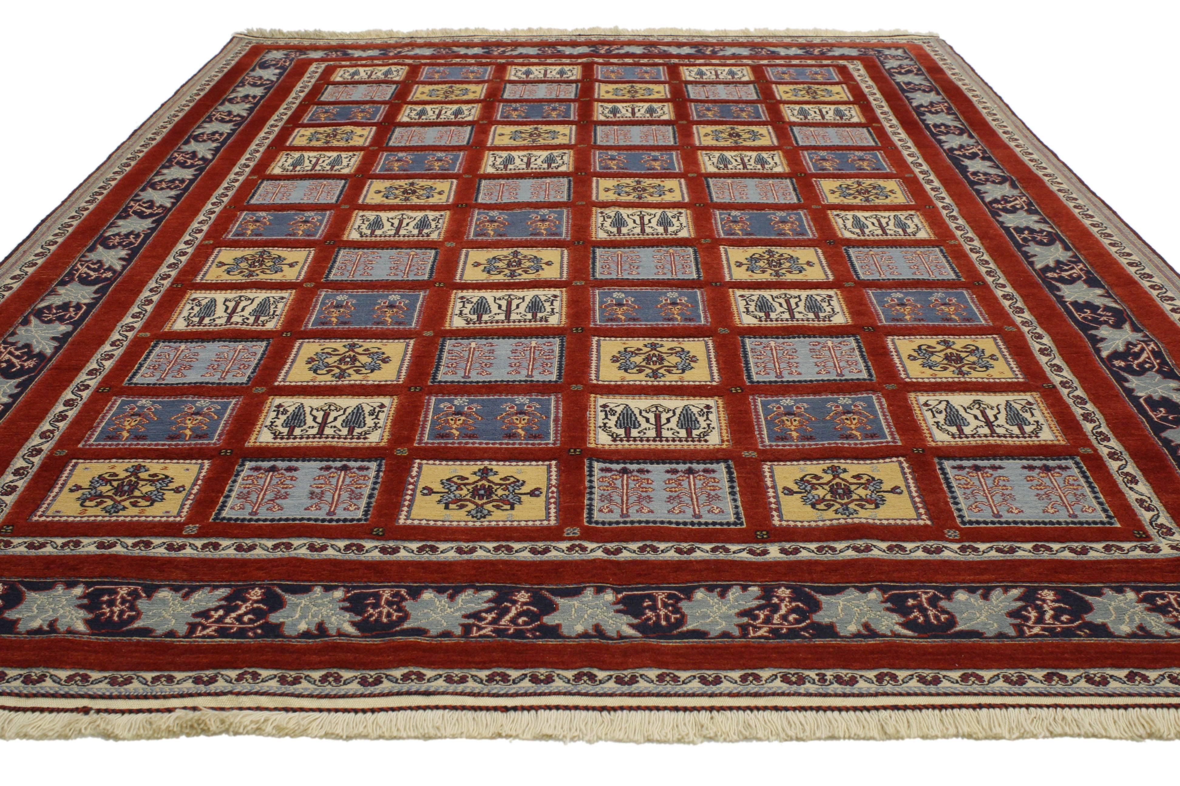 Primary colors integrated with a rich patina, this vintage Gabbeh Indian rug features the Four Seasons design with a traditional modern style. Classically composed and boasting a truly magnificent Four Seasons panel compartment garden design, this