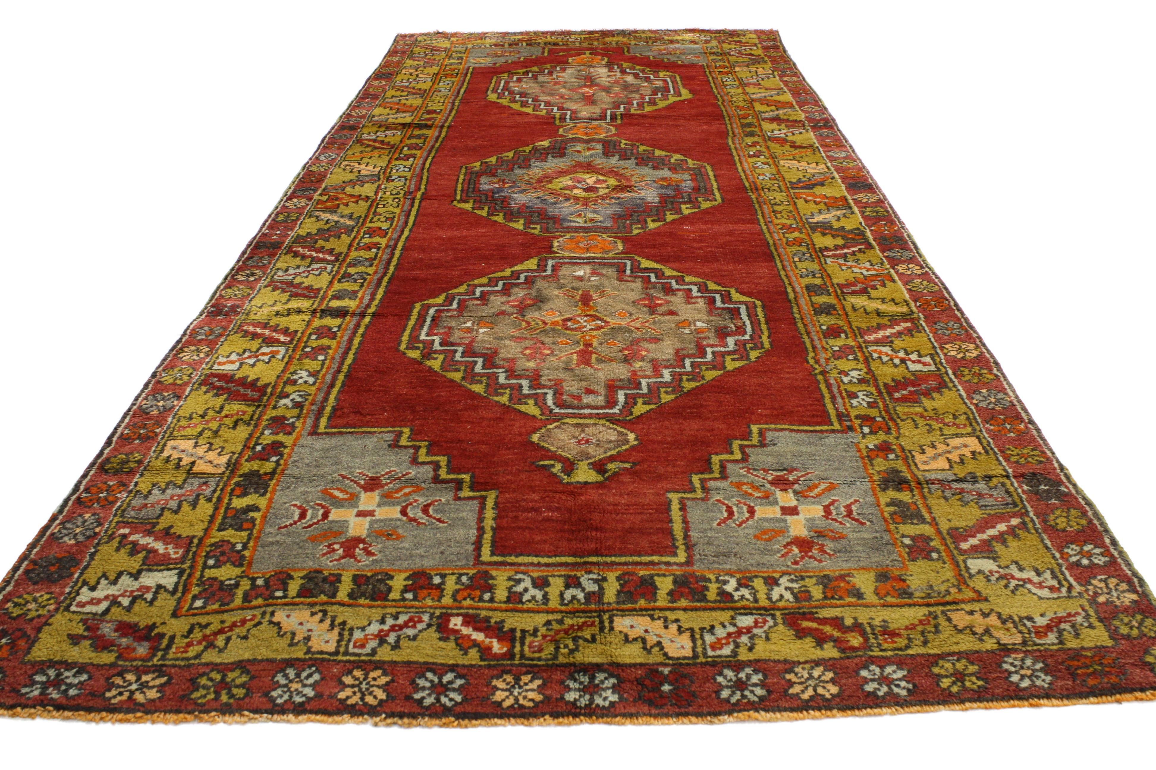 52057 Vintage Turkish Oushak Runner with Modern Tribal Style, Wide Hallway Runner. This hand-knotted wool vintage Turkish Oushak carpet runner features three hexagonal medallions with hooked edges on an abrashed red field. It is enclosed with gray